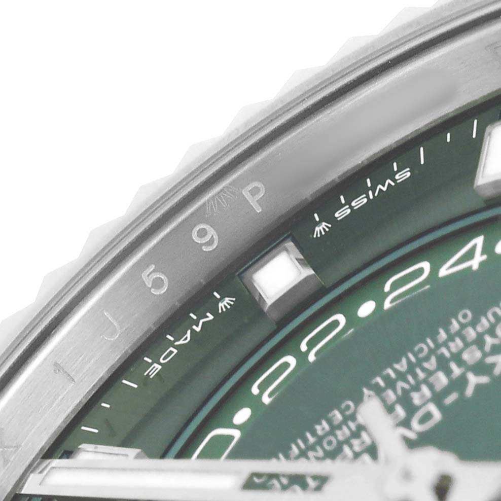 The close-up angle shows the edge of the bezel and part of the dial on the Rolex Sky-Dweller 336934 Men's Stainless Steel Green Dial.