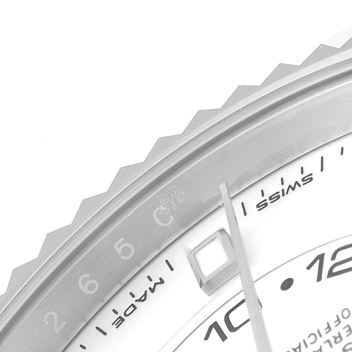 This image shows a close-up of the bezel, dial, and a hand of the Rolex Sky-Dweller 326934 Men's Stainless Steel White Dial 326934 Men's Stainless Steel White Dial watch.