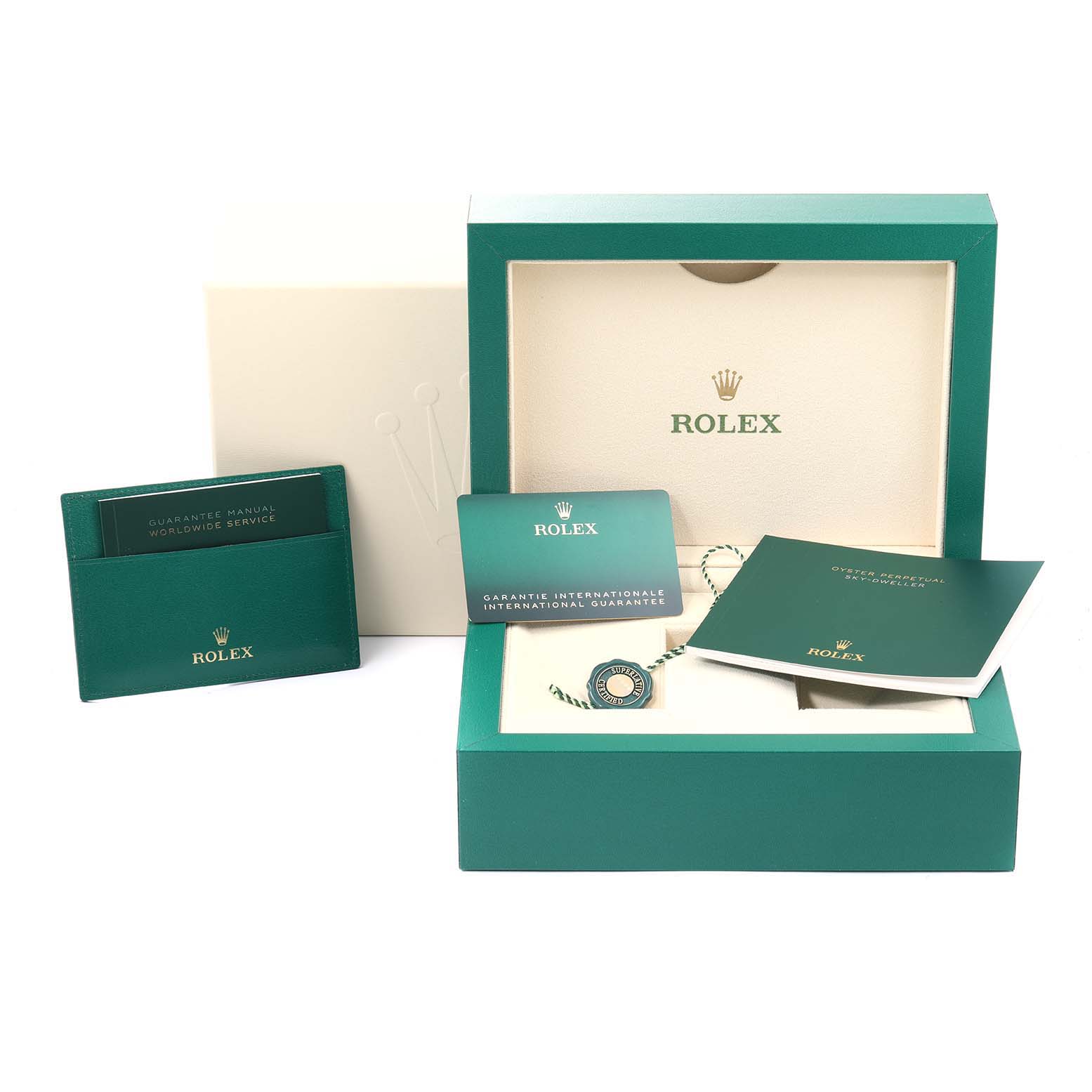 The image shows the packaging and accessories for a Rolex Sky-Dweller 326934 Men's Stainless Steel White Dial 326934 Men's Stainless Steel White Dial, including a box, manuals, and guarantee card.