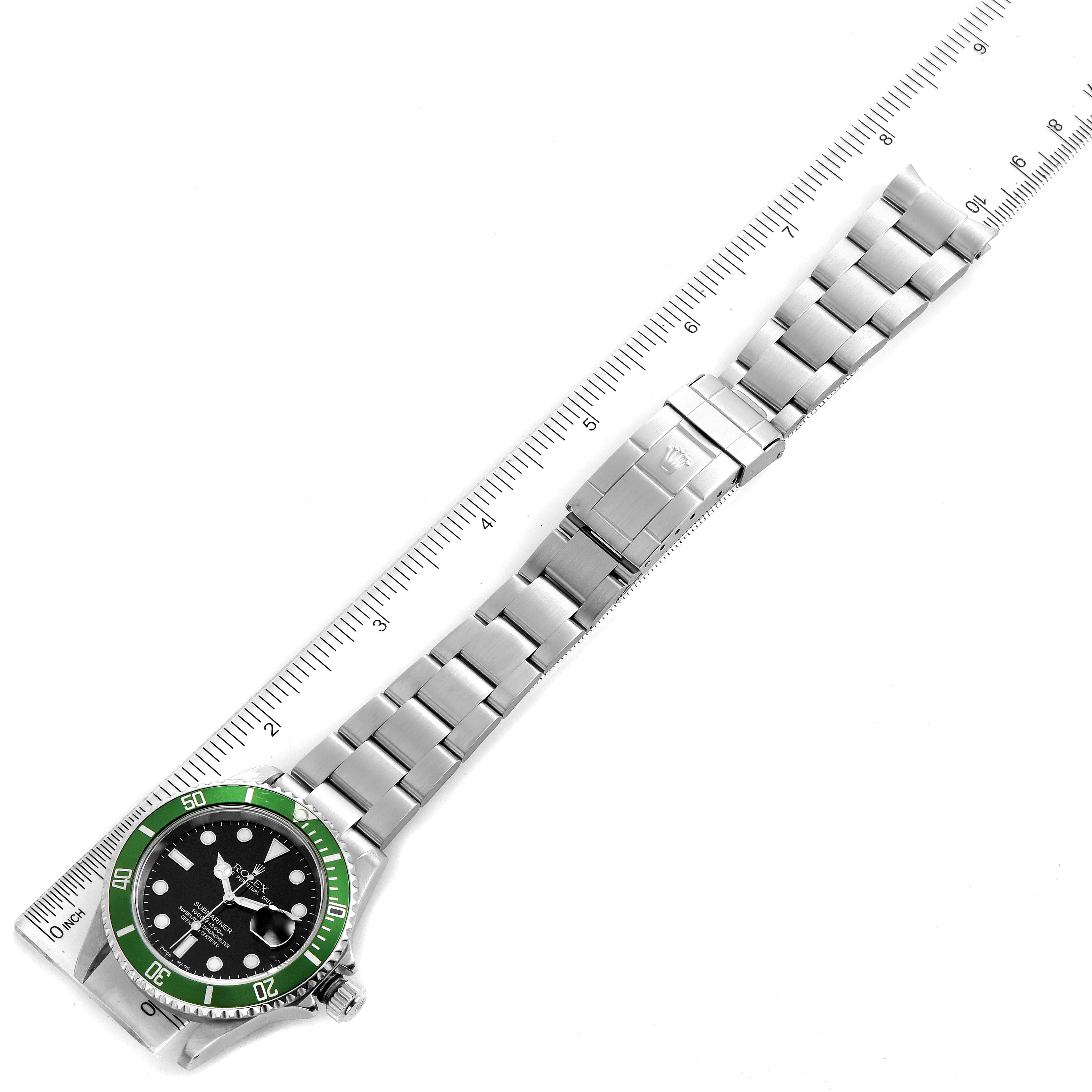 The Rolex Submariner 16610LV Men
s Stainless Steel Black Dial 16610LV Men
s Stainless Steel Black Dial watch is shown laid flat, displaying its face, bezel, and stainless steel bracelet near a ruler.