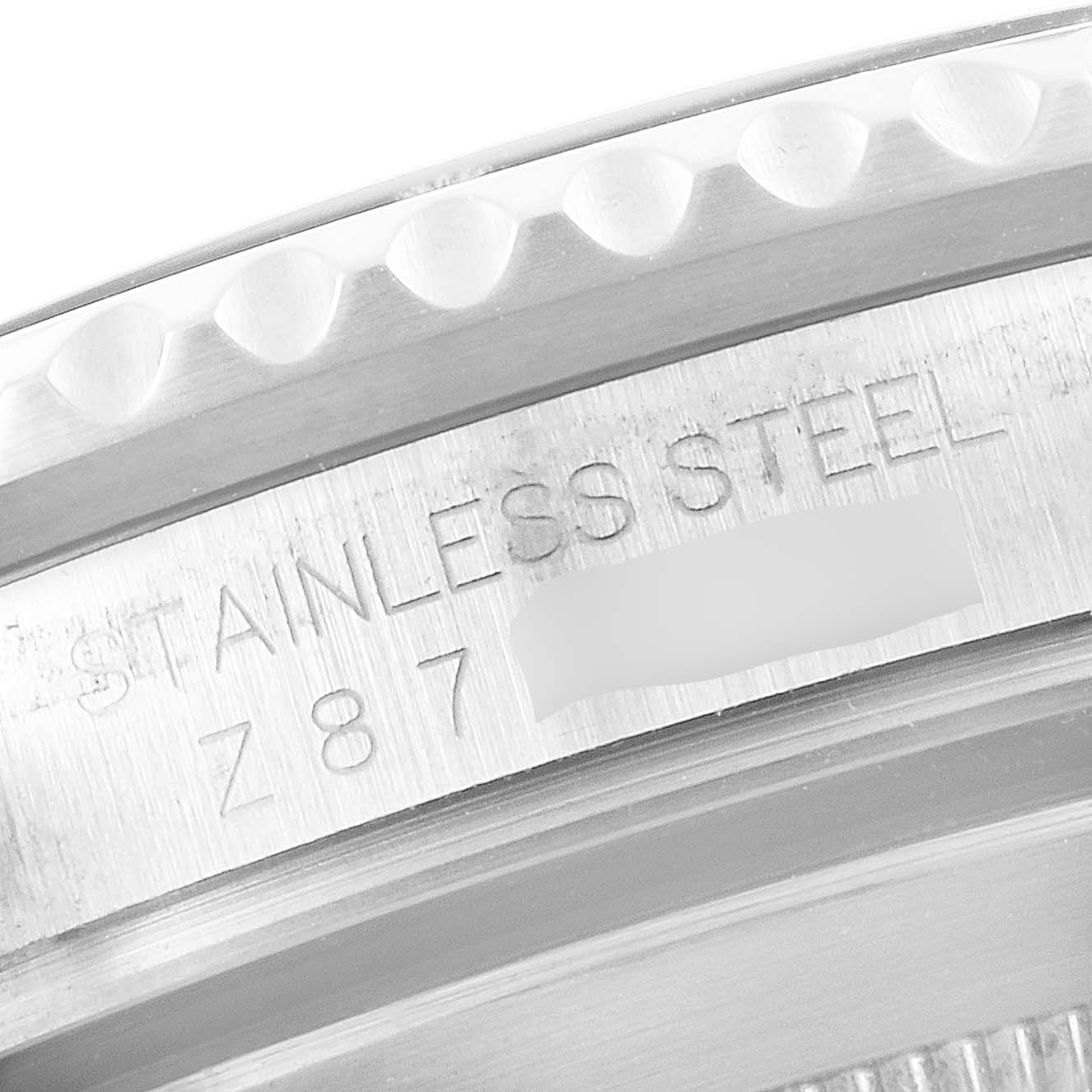 This image shows a close-up of the engraved bezel edge and side markings of a Rolex Submariner 16610 Men
s Stainless Steel Black Dial 16610 Men
s Stainless Steel Black Dial watch.