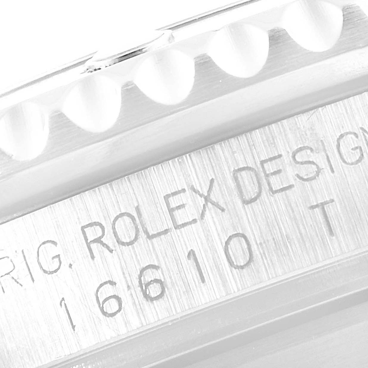 This image shows a close-up angle of the engraved side of the Rolex Submariner 16610 Men
s Stainless Steel Black Dial 16610 Men
s Stainless Steel Black Dial model 16610, highlighting its bezel and case.