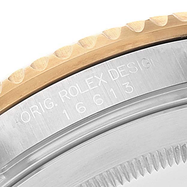 This close-up shot of the Rolex Submariner 16613 Men
s Steel and Gold (two tone) Blue Dial 16613 Men
s Steel and Gold (two tone) Blue Dial shows the model number 16613 engraved on its case.