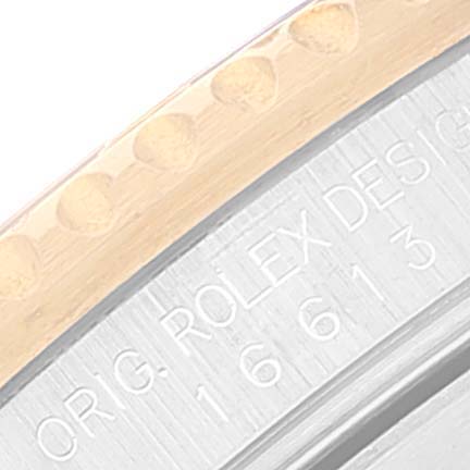 This image shows a close-up of the edge of the bezel and case of a Rolex Submariner 16613 Men
s Steel and Gold (two tone) Blue Dial 16613 Men
s Steel and Gold (two tone) Blue Dial, featuring the engraved model number.