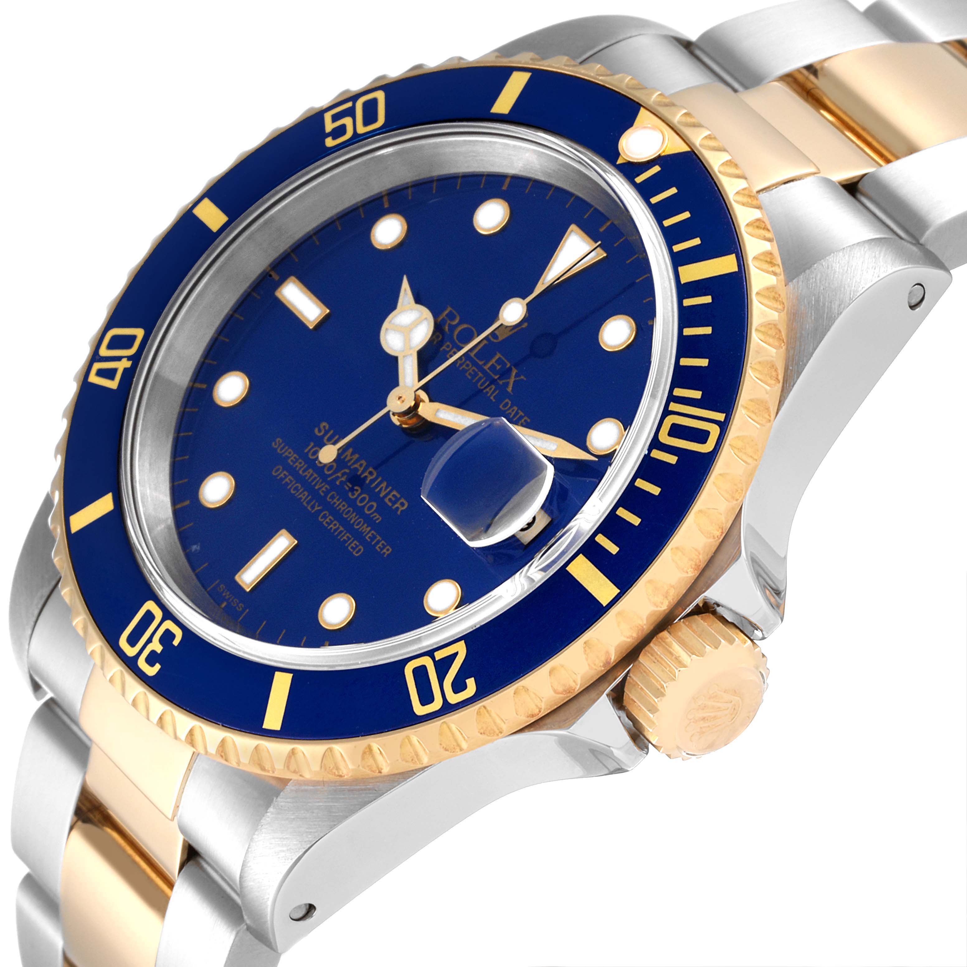 The image shows a close-up angle of a Rolex Submariner 16613 Men
s Steel and Gold (two tone) Blue Dial 16613 Men
s Steel and Gold (two tone) Blue Dial, highlighting the blue dial, gold bezel, crown, and two-tone bracelet.