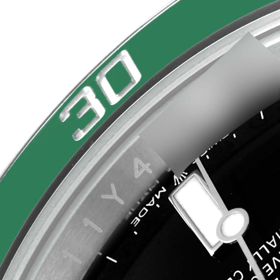 The image shows a close-up of the 30-minute marker and part of the dial with a hand on the Rolex Submariner 126610LV Men's Stainless Steel Black Dial 126610LV Men's Stainless Steel Black Dial watch.