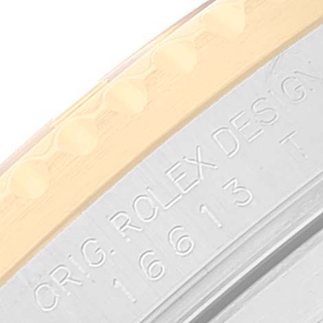 This image shows a close-up of the side inscription and part of the bezel of a Rolex Submariner 16613 Men's Steel and Gold (two tone) Black Dial 16613 Men's Steel and Gold (two tone) Black Dial watch.