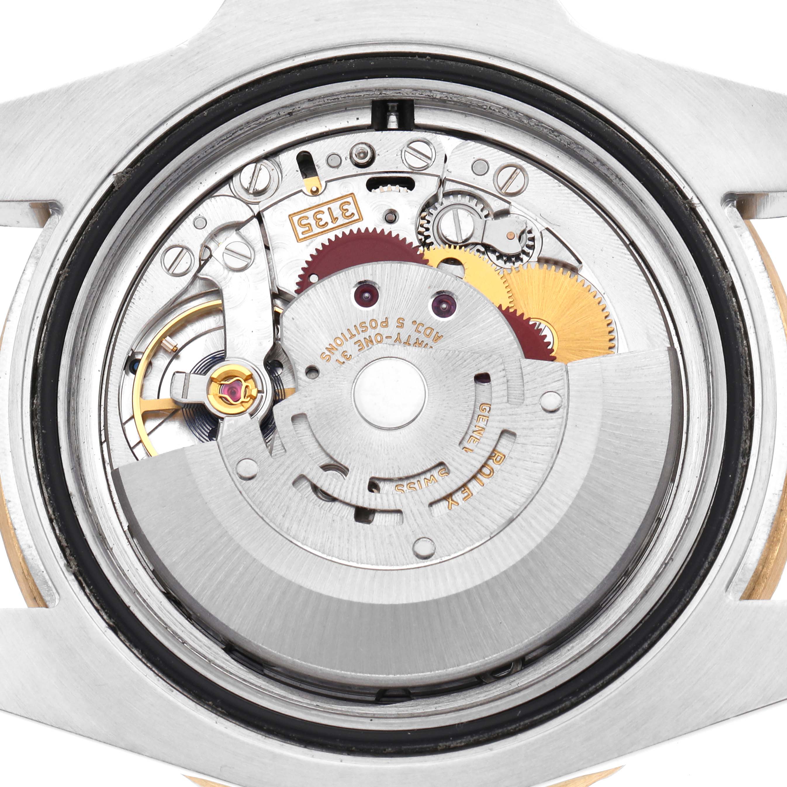 The image shows a top-down view of the Rolex Submariner 116613 Men
s Steel and Gold (two tone) Blue Dial 116613 Men
s Steel and Gold (two tone) Blue Dial
s internal mechanism, highlighting the movement and rotor components.