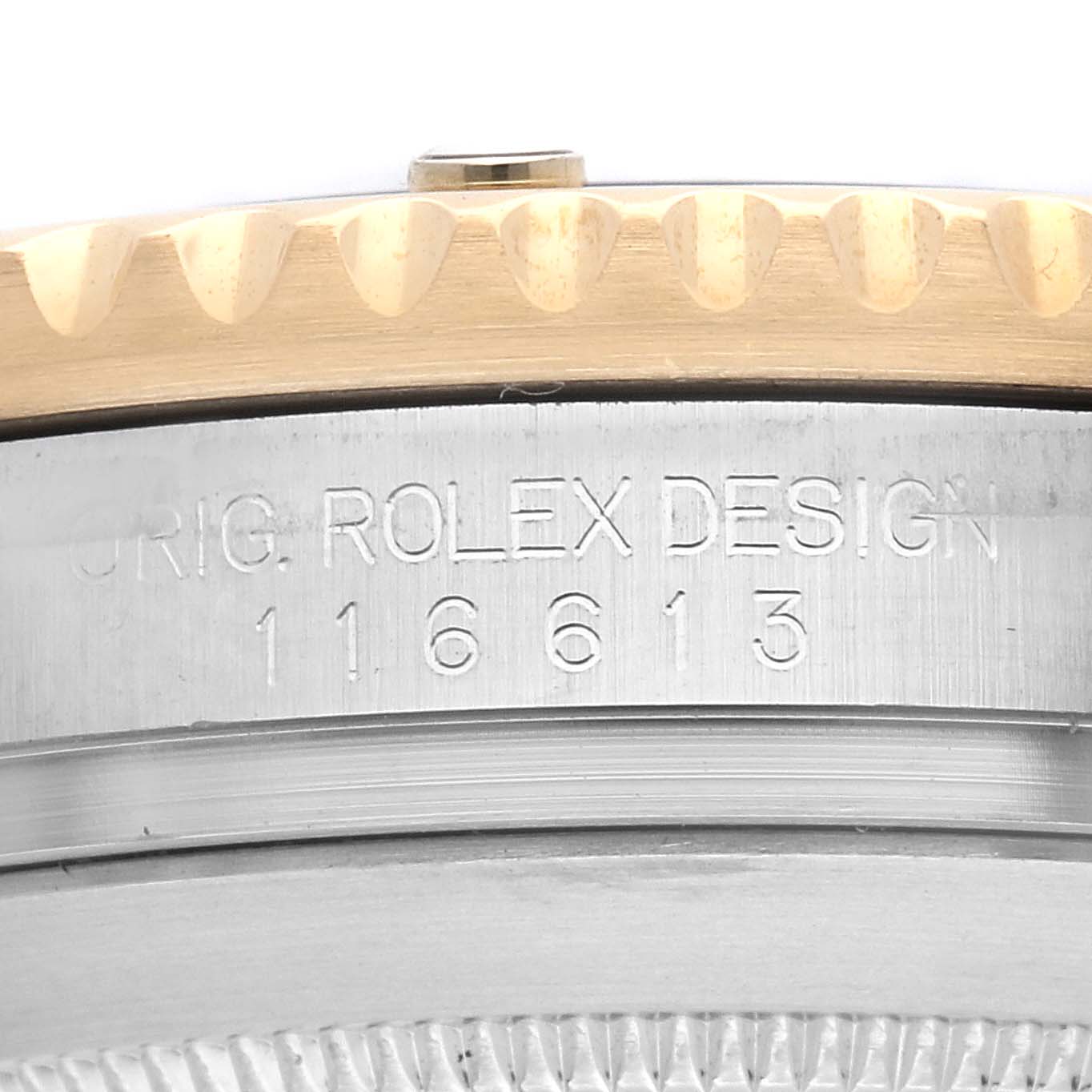 The image shows a side close-up of a Rolex Submariner 116613 Men
s Steel and Gold (two tone) Blue Dial 116613 Men
s Steel and Gold (two tone) Blue Dial bezel and case with engraved model details.