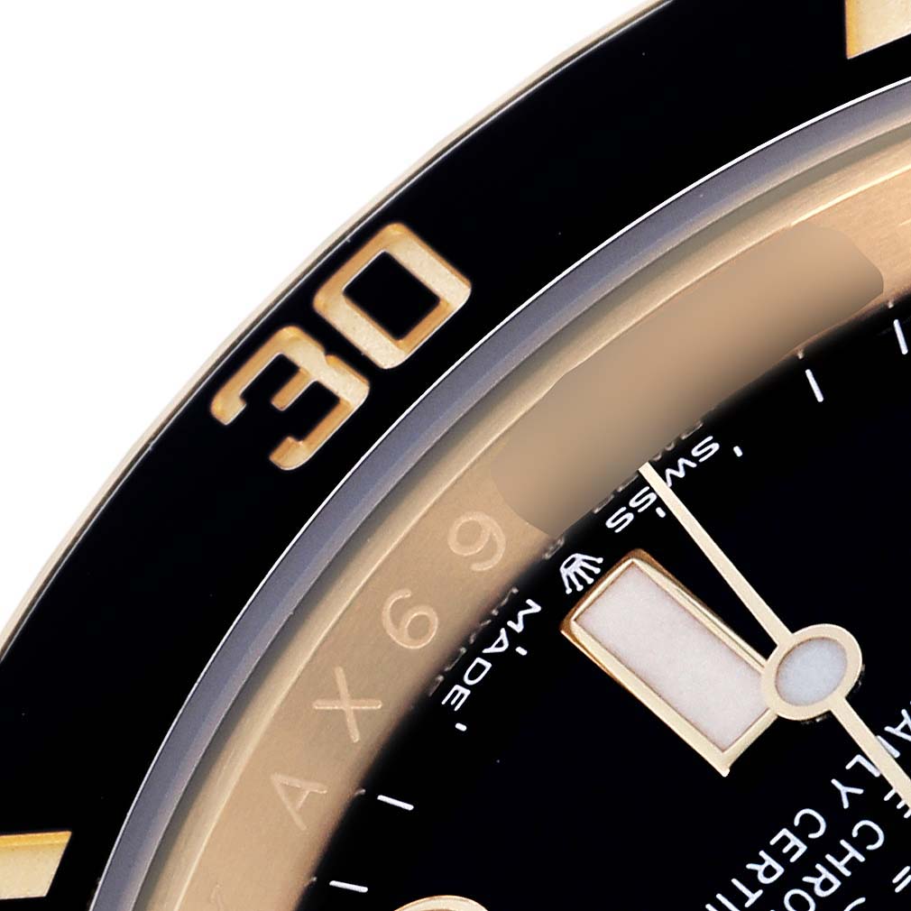 The image shows a close-up angle of the Rolex Submariner 126618 Men
s Yellow Gold Black Dial 126618 Men
s Yellow Gold Black Dial
s bezel with the number "30" and part of the dial with the hour marker.