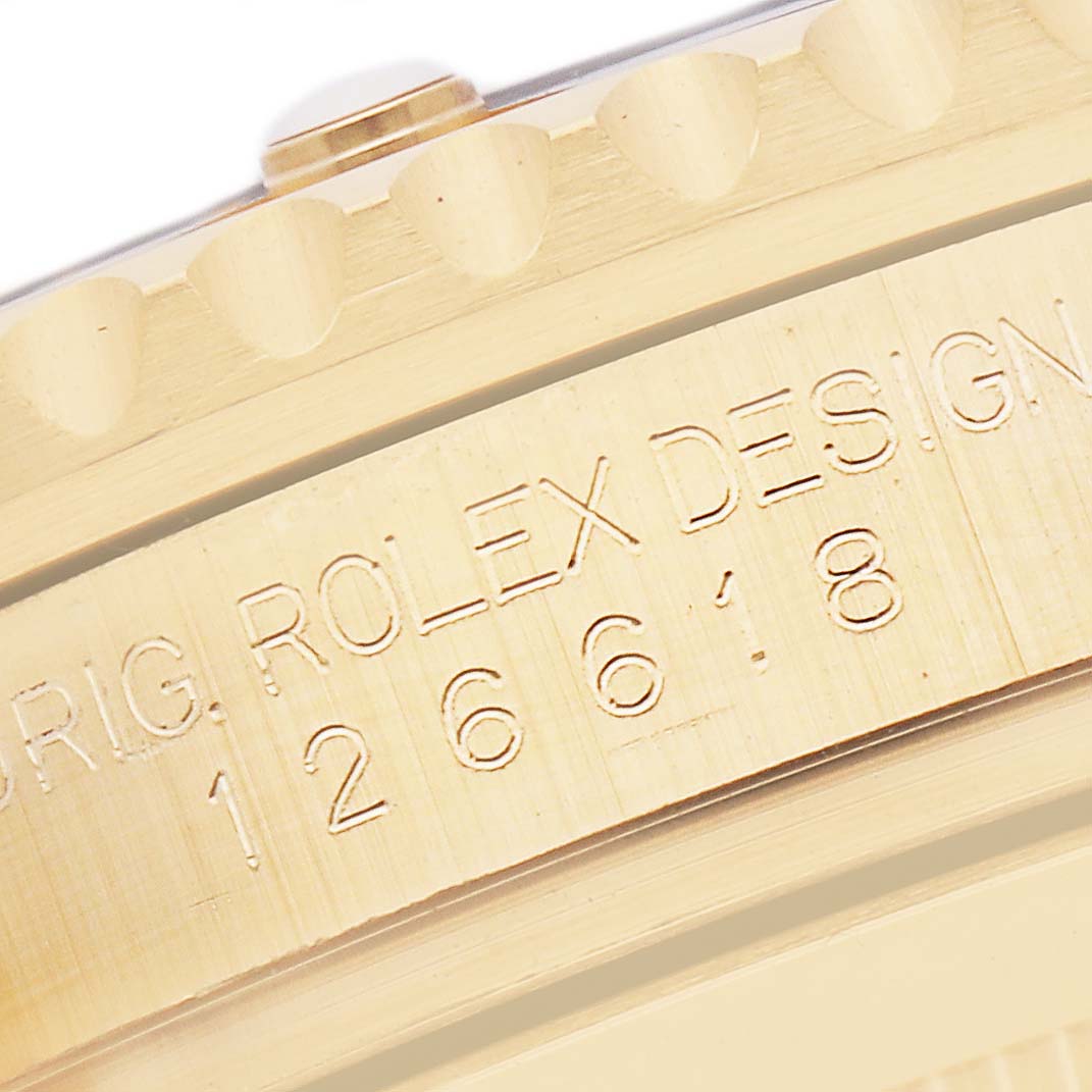 The image shows a close-up of the engraved side of a Rolex Submariner 126618 Men
s Yellow Gold Black Dial 126618 Men
s Yellow Gold Black Dial watch case.