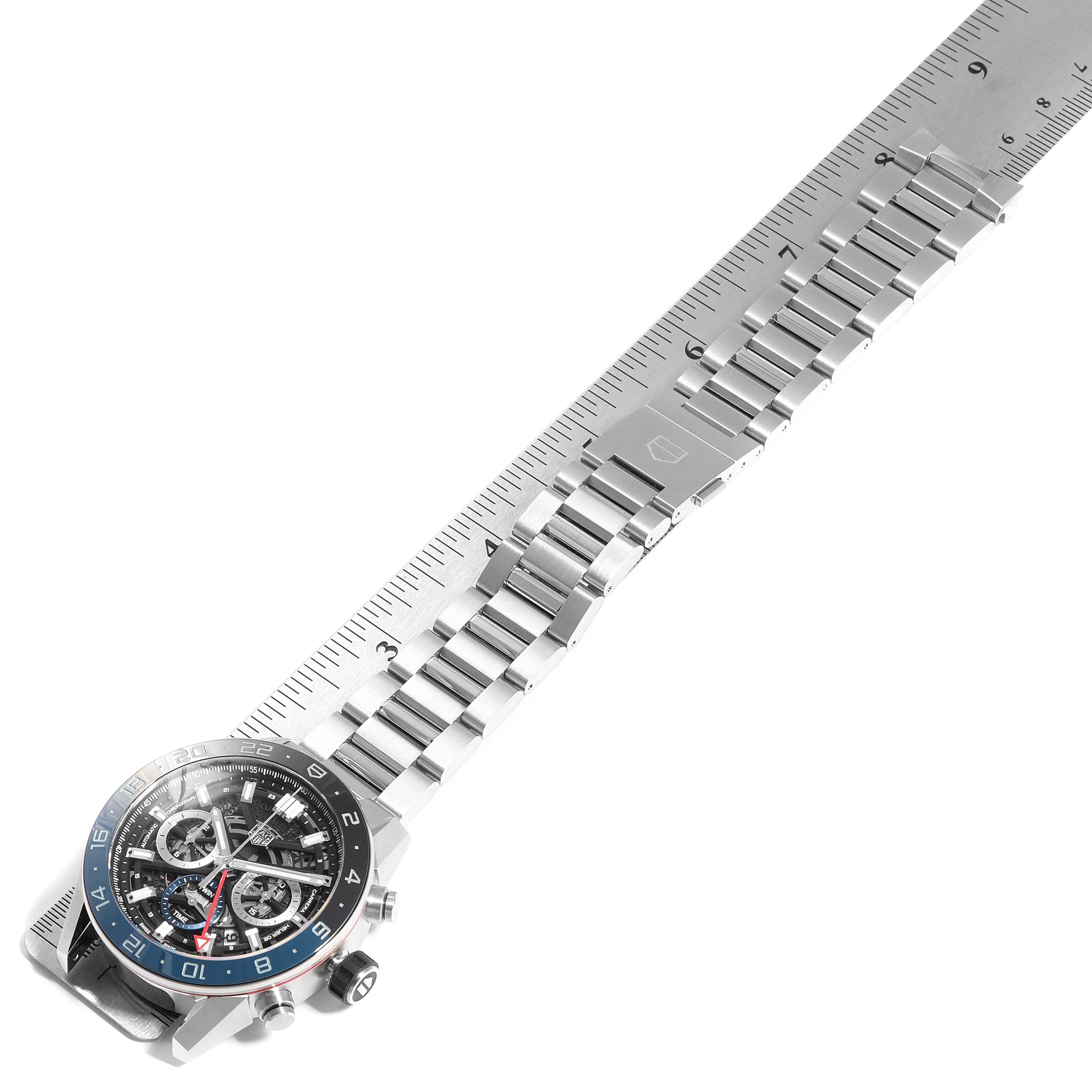 The image shows a Tag Heuer Carrera CBG2A1Z.BA0658  Men
s Stainless Steel Black Dial CBG2A1Z.BA0658  Men
s Stainless Steel Black Dial watch laid flat with a focus on the face and bracelet, aligned with a ruler for measurement.