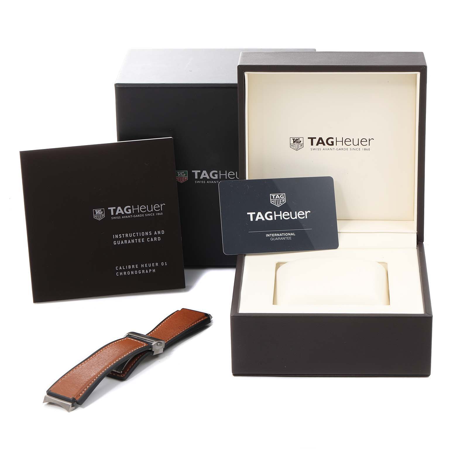 The image shows the Tag Heuer Carrera CAR2A8A.FT6072 Men's Titanium Grey Dial CAR2A8A.FT6072 Men's Titanium Grey Dial watch's box, instructions, guarantee card, and an additional watch strap.