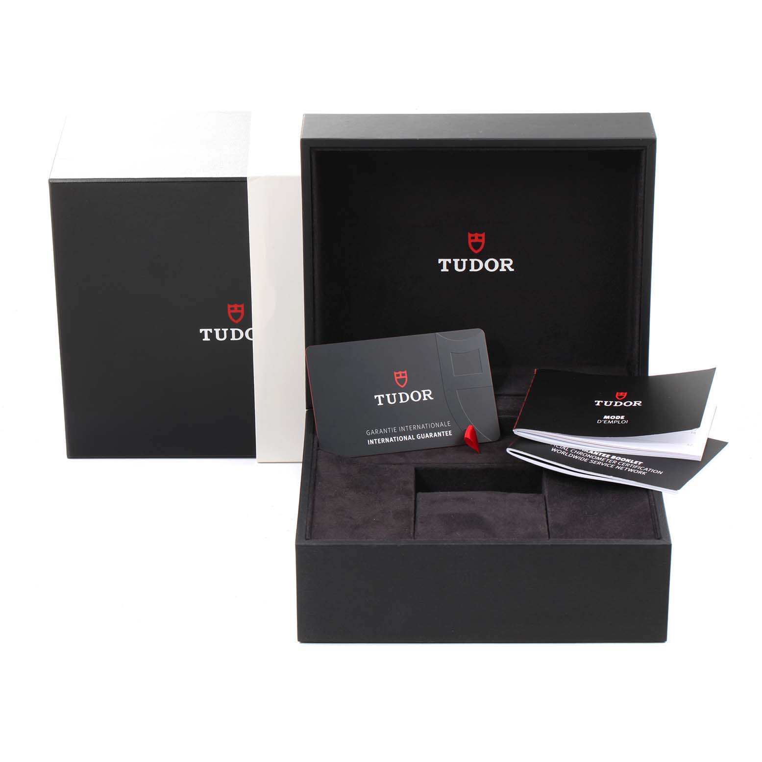 The image shows the packaging and accessories for the Tudor Heritage Black Bay 79030N Men
s Stainless Steel Black Dial 79030N Men
s Stainless Steel Black Dial watch, including the box and warranty cards.