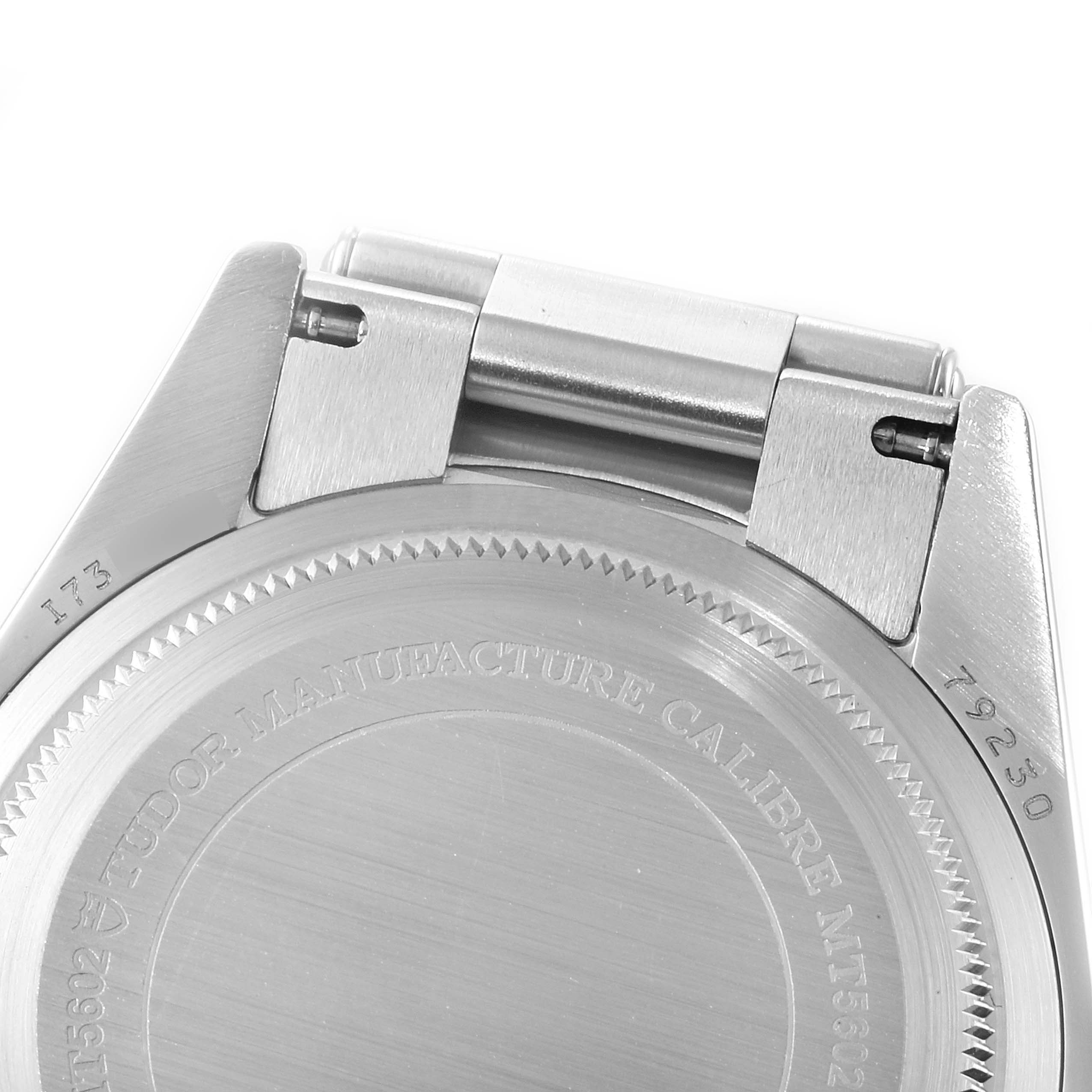 The image shows the backside of a Tudor Heritage Black Bay 79230R Men
s Stainless Steel Black Dial 79230R Men
s Stainless Steel Black Dial watch, focusing on the case back and the lugs.