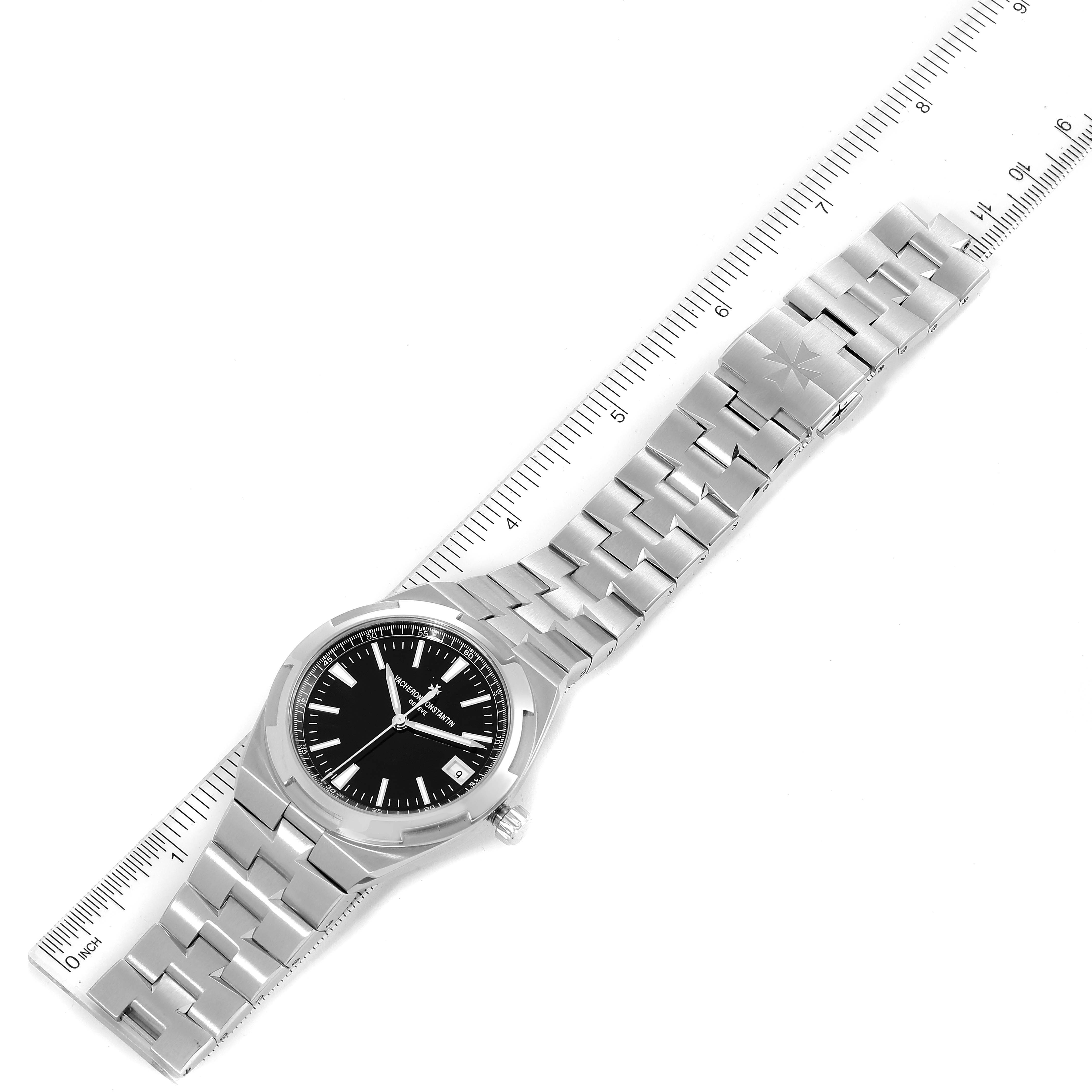 The image shows a top-down view of a Vacheron Constantin Overseas 4500V/110A Men's Stainless Steel Black Dial 4500V/110A Men's Stainless Steel Black Dial model watch with a ruler beside it highlighting its length.