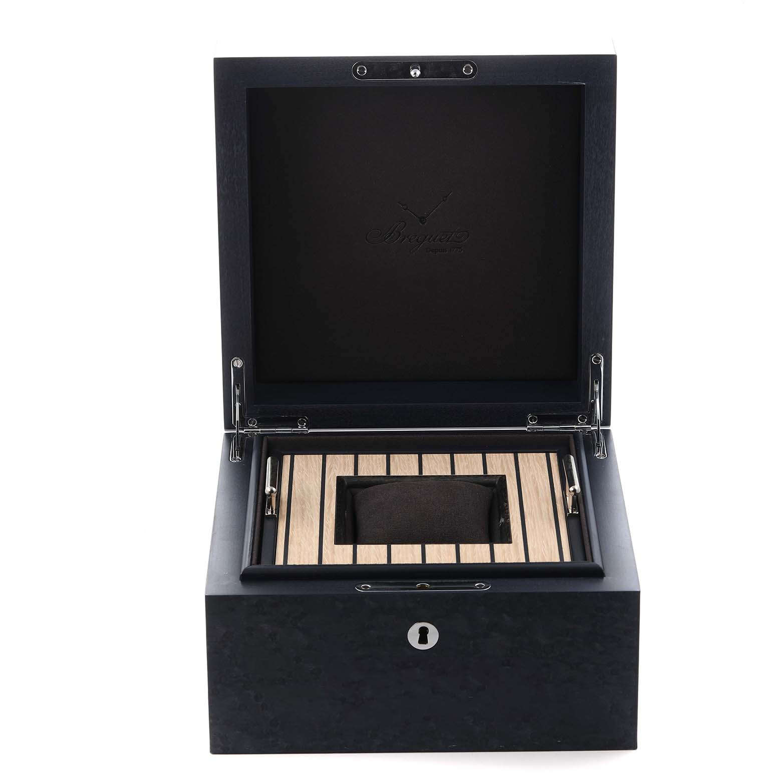 The image shows an open box for the Breguet Marine 5527BR/12/5WV Men's Rose Gold Silver Dial 5527BR/12/5WV Men's Rose Gold Silver Dial model, featuring a cushion and elegant wood paneling inside.