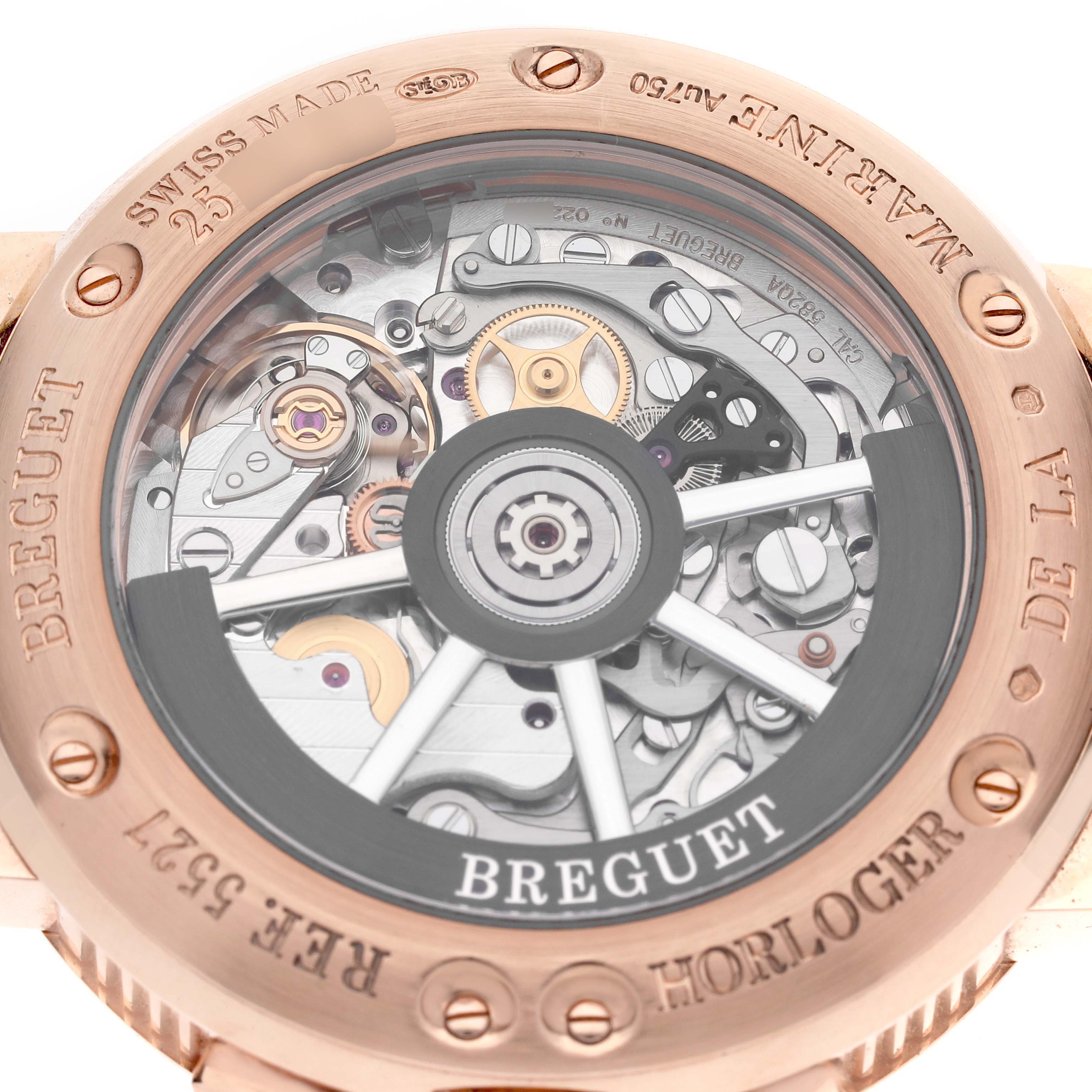 The image shows the backside of the Breguet Marine 5527BR/12/5WV Men's Rose Gold Silver Dial 5527BR/12/5WV Men's Rose Gold Silver Dial watch, highlighting its intricate movement through a transparent case back.