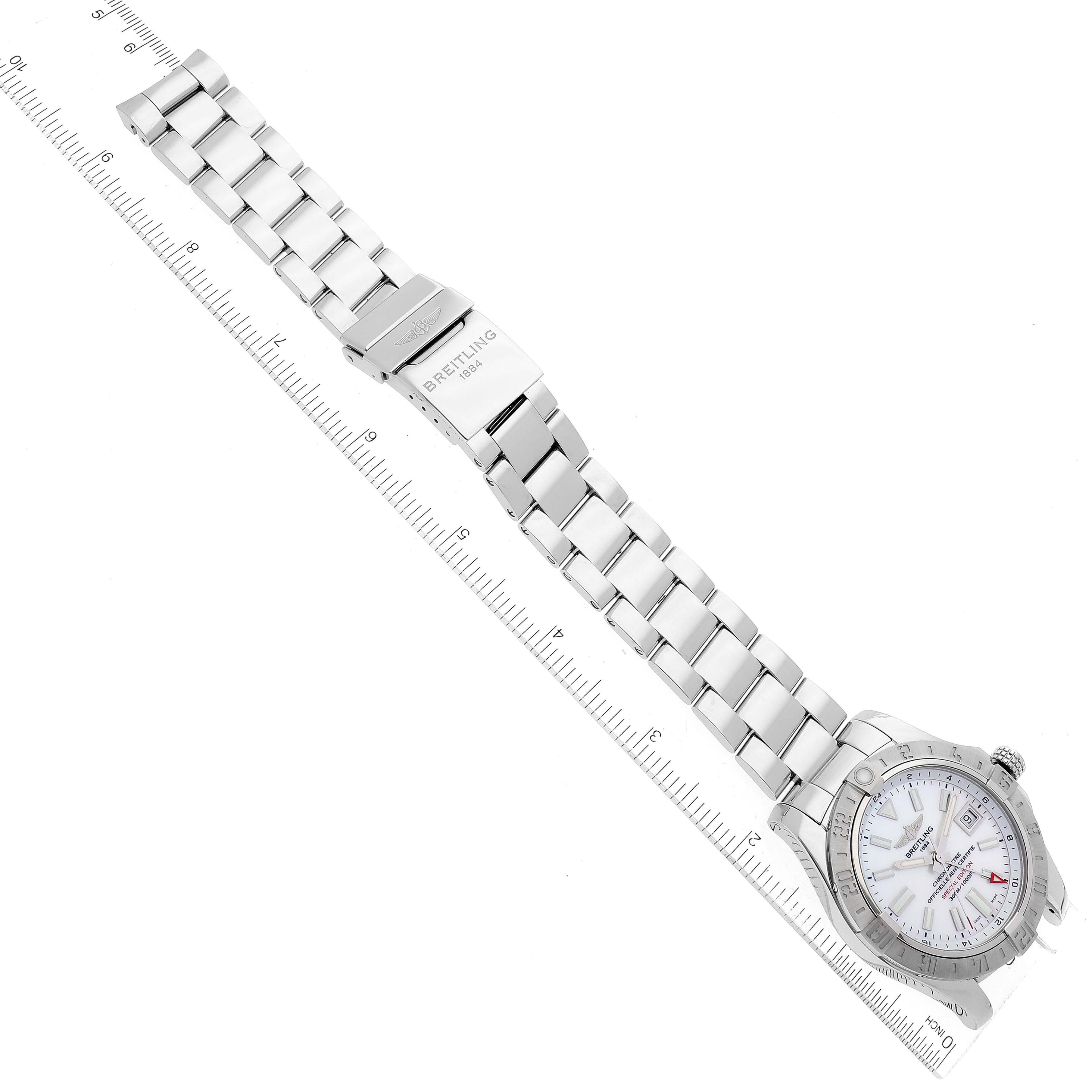 The Breitling Avenger A3239011 Men's Stainless Steel Mother of Pearl Dial A3239011 Men's Stainless Steel Mother of Pearl Dial watch is shown at an overhead angle with its full bracelet and clasp displayed next to a ruler.