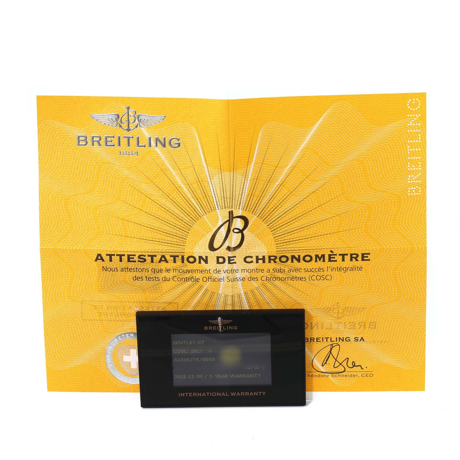 The image shows a Breitling Bentley A133627X Men's Stainless Steel Mother of Pearl Dial A133627X Men's Stainless Steel Mother of Pearl Dial model's warranty card and chronometer certificate at a top-down angle.