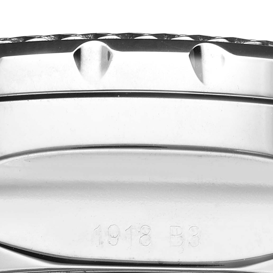 This close-up image shows the side view of the case and bezel of the Bentley model by Breitling, including some markings.