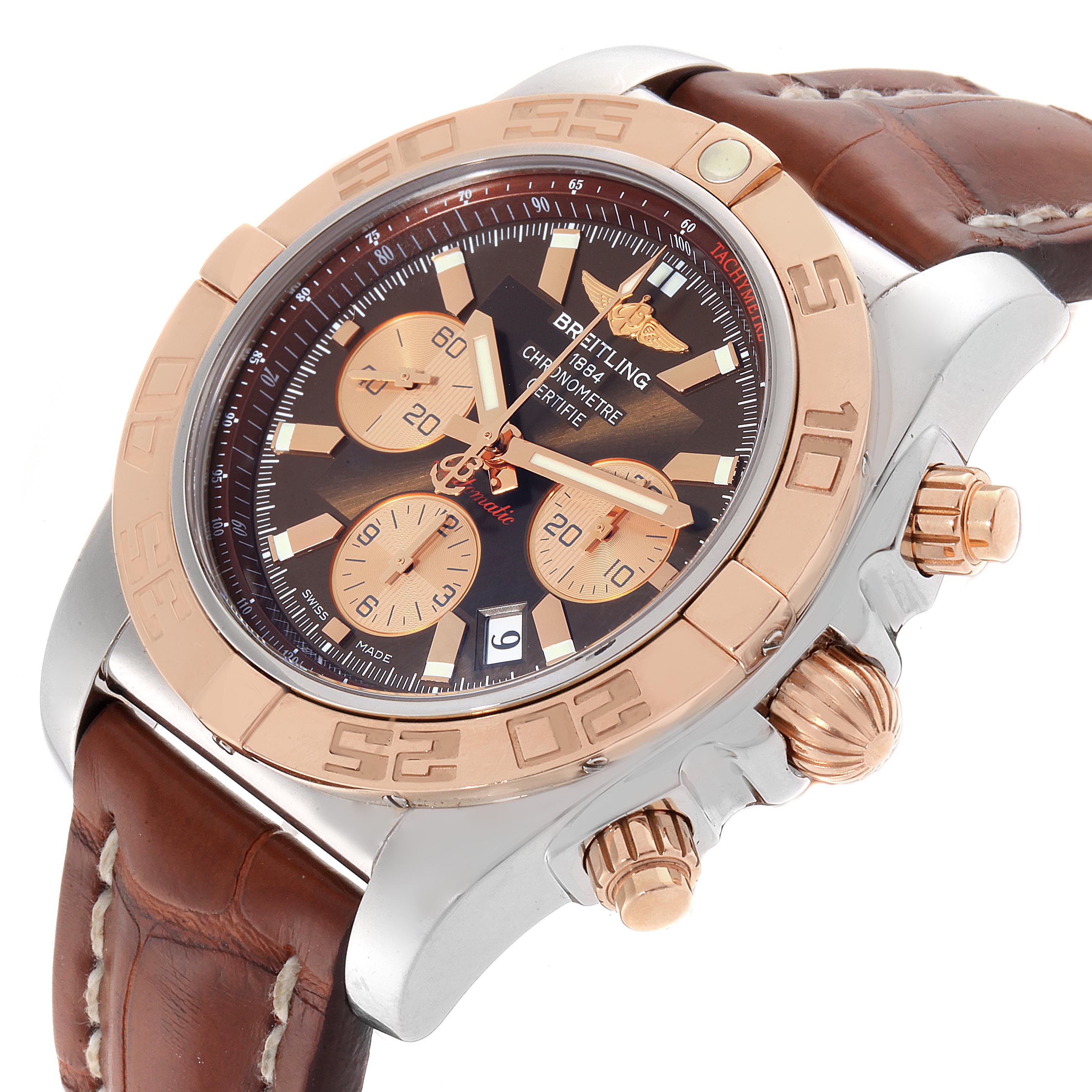 The image shows a close-up angle of the Breitling Chronomat CB0110 Men
s Steel and Gold (two tone) Brown Dial CB0110 Men
s Steel and Gold (two tone) Brown Dial watch, highlighting its dial, bezel, crown, and strap.
