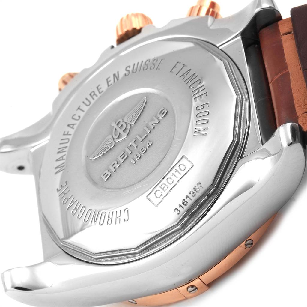 The image shows the back case and part of the strap and crown of a Breitling Chronomat CB0110 Men
s Steel and Gold (two tone) Brown Dial CB0110 Men
s Steel and Gold (two tone) Brown Dial watch.