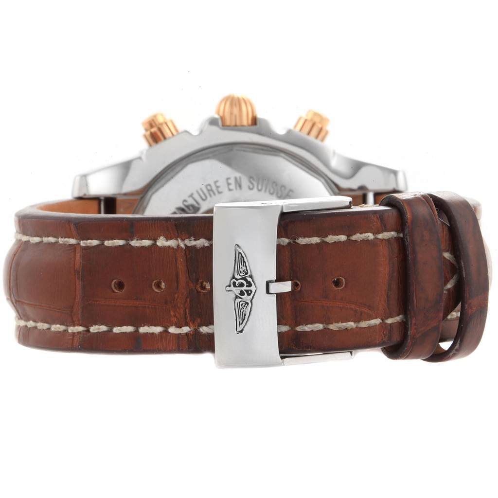The image shows the back view of the Breitling Chronomat CB0110 Men
s Steel and Gold (two tone) Brown Dial CB0110 Men
s Steel and Gold (two tone) Brown Dial watch, focusing on the leather strap and metal clasp.