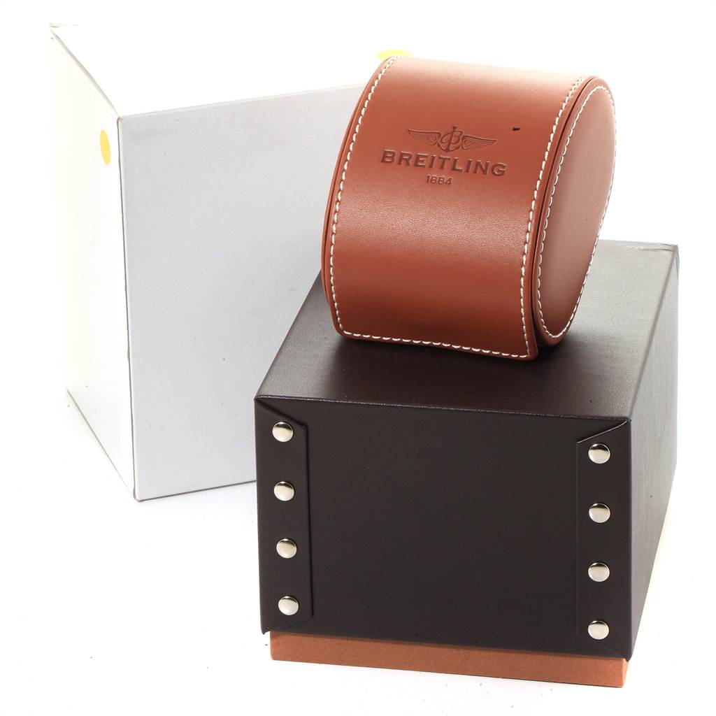 This image shows the packaging for a Breitling Chronomat CB0110 Men
s Steel and Gold (two tone) Brown Dial CB0110 Men
s Steel and Gold (two tone) Brown Dial watch, including a brown leather case and a sturdy black box with rivets.