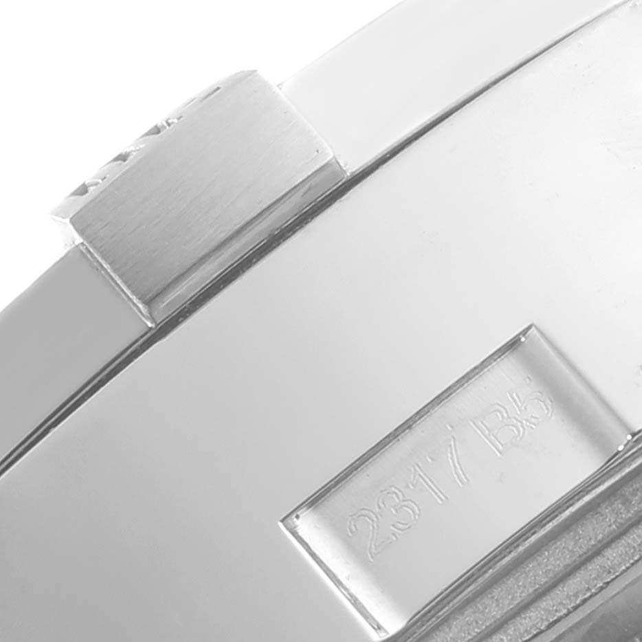 The image shows a close-up of the side view of a Breitling Avenger A13381 Men's Stainless Steel Mother of Pearl Dial A13381 Men's Stainless Steel Mother of Pearl Dial watch, focusing on the crown and engraved serial number.