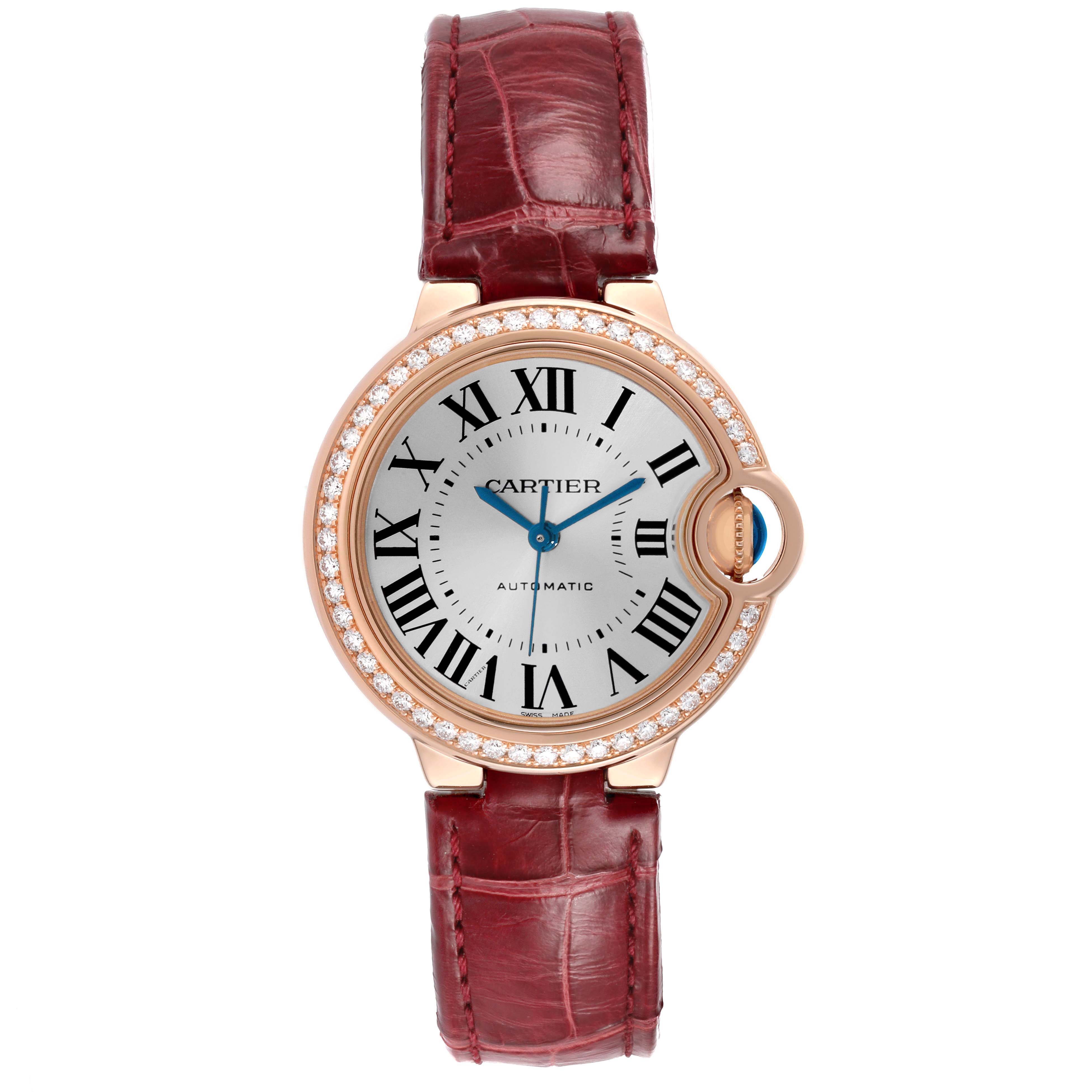 The Cartier Ballon Bleu WJBB0033 Women's Rose Gold Silver Dial watch is shown from a top view, highlighting its round face, Roman numerals, diamond bezel, and red leather strap.