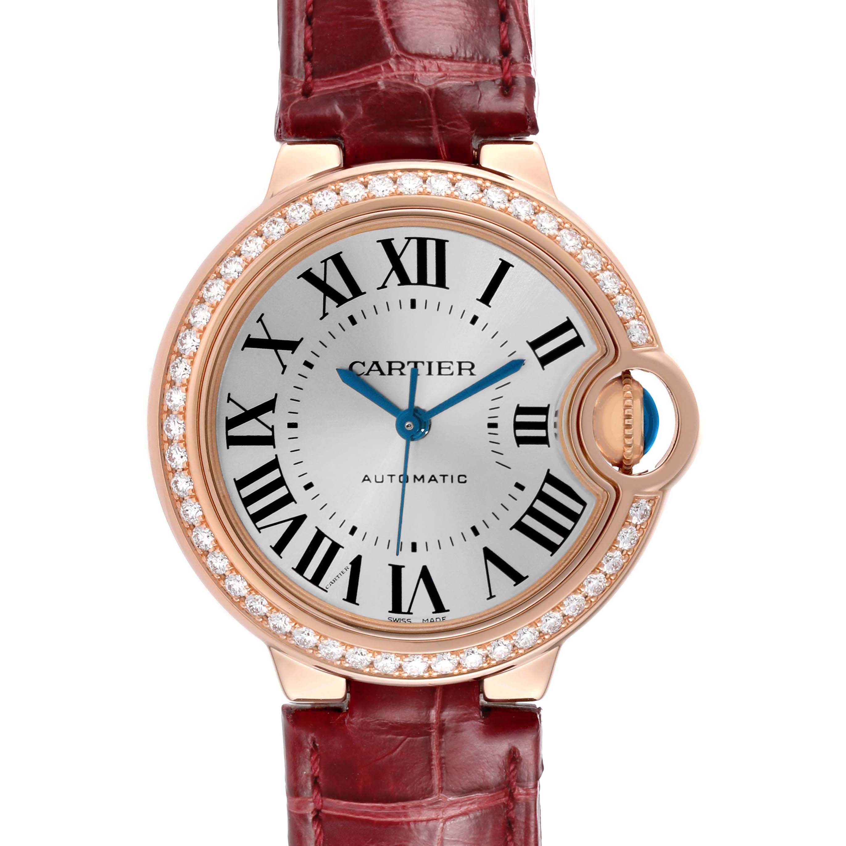 The Cartier Ballon Bleu WJBB0033 Women's Rose Gold Silver Dial watch is shown from the front, highlighting its Roman numerals, diamond bezel, and red leather strap.