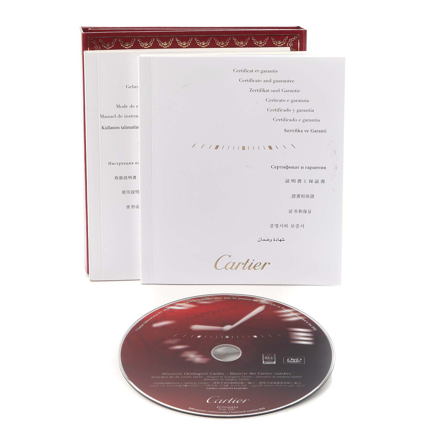 The image shows the Cartier Ballon Bleu W69017Z4 Men
s Stainless Steel Silver Dial W69017Z4 Men
s Stainless Steel Silver Dial
s warranty certificate, manual, and a DVD at a slight angle.