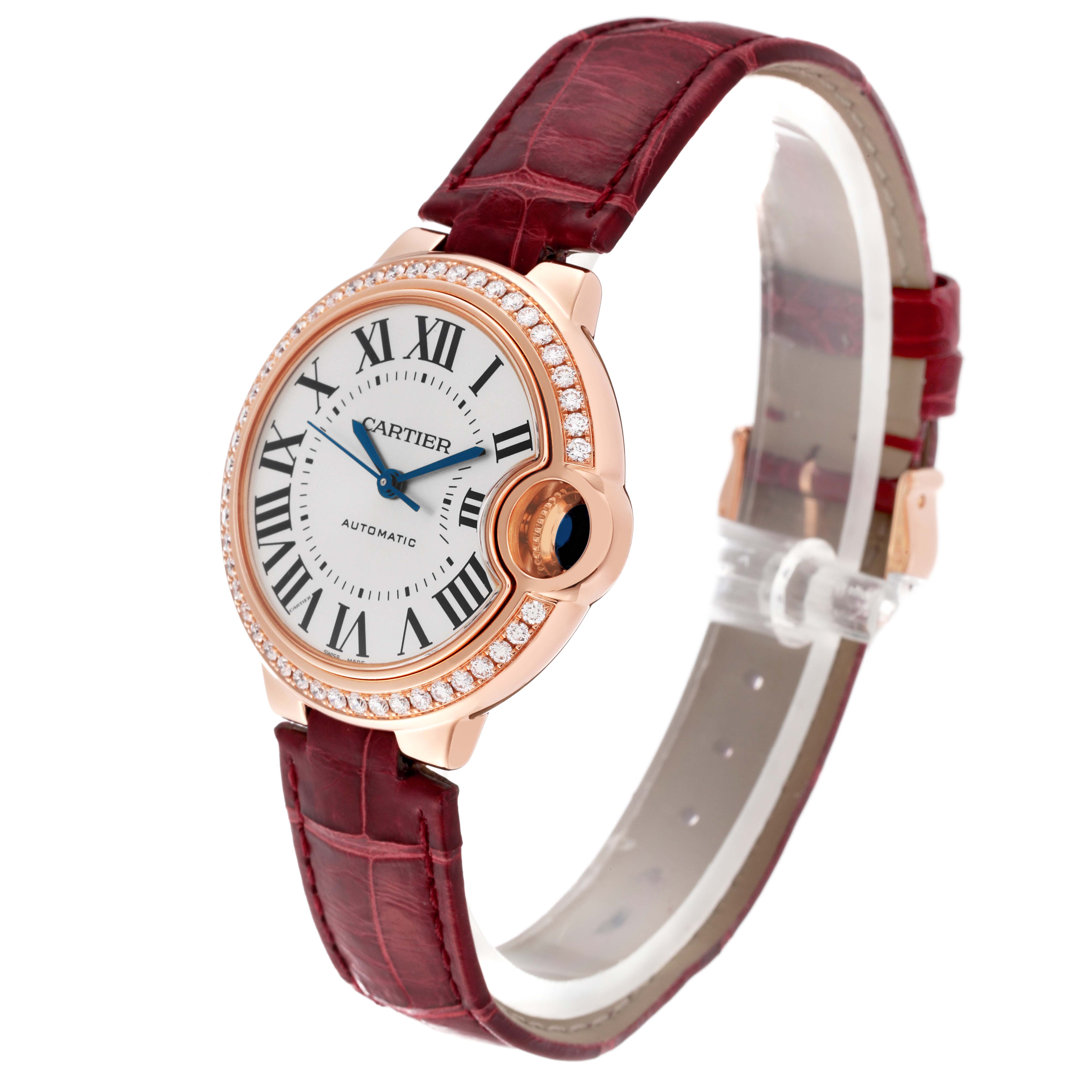 This image shows a side angle view of a Cartier Ballon Bleu WJBB0033 Women's Rose Gold Silver Dial WJBB0033 Women's Rose Gold Silver Dial watch with a red leather strap and diamond-accented bezel.