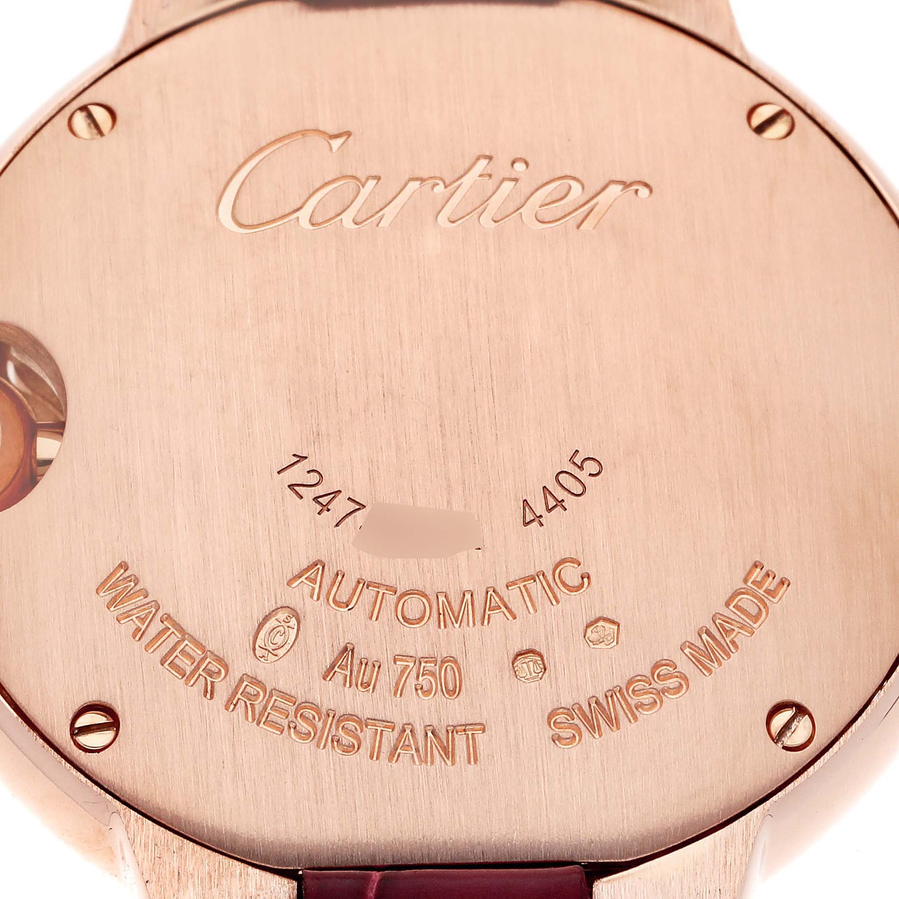 This image shows the back case of a Ballon Bleu by Cartier, highlighting the inscriptions and engravings.
