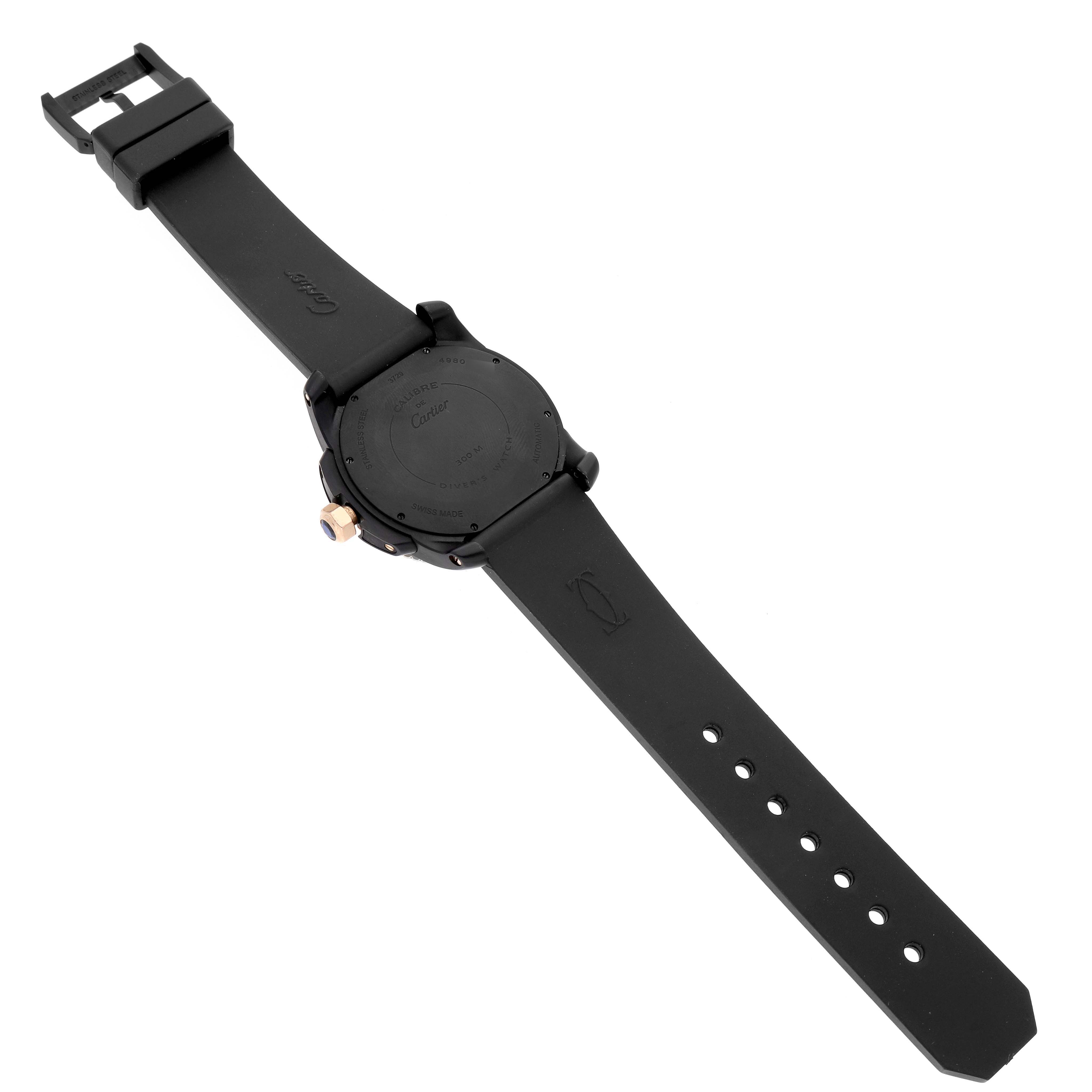The image shows a Calibre de Cartier watch by Cartier from the back, displaying the case back and black strap.
