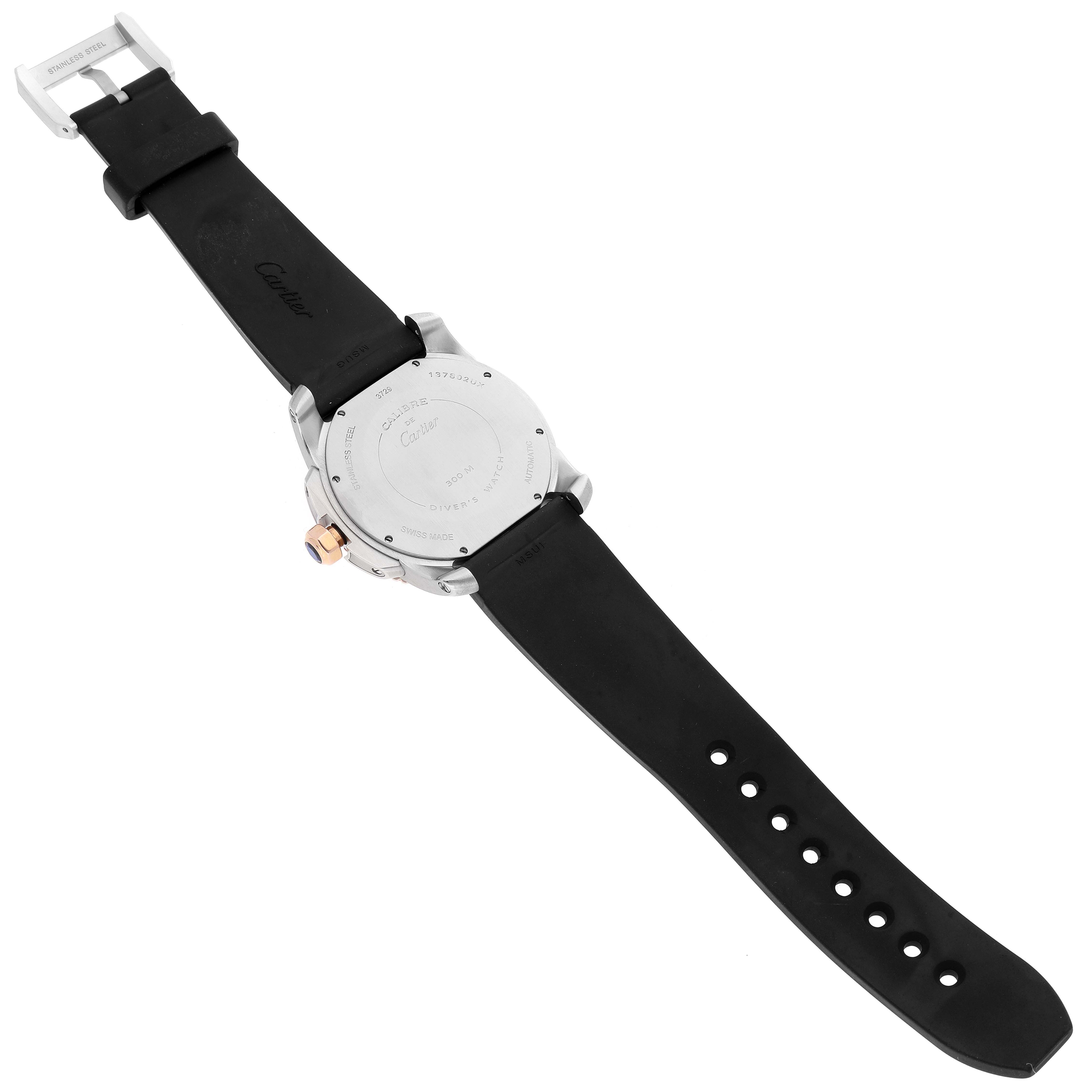 The image shows the back view of a Calibre de Cartier watch by Cartier, displaying its case back, strap, and buckle.