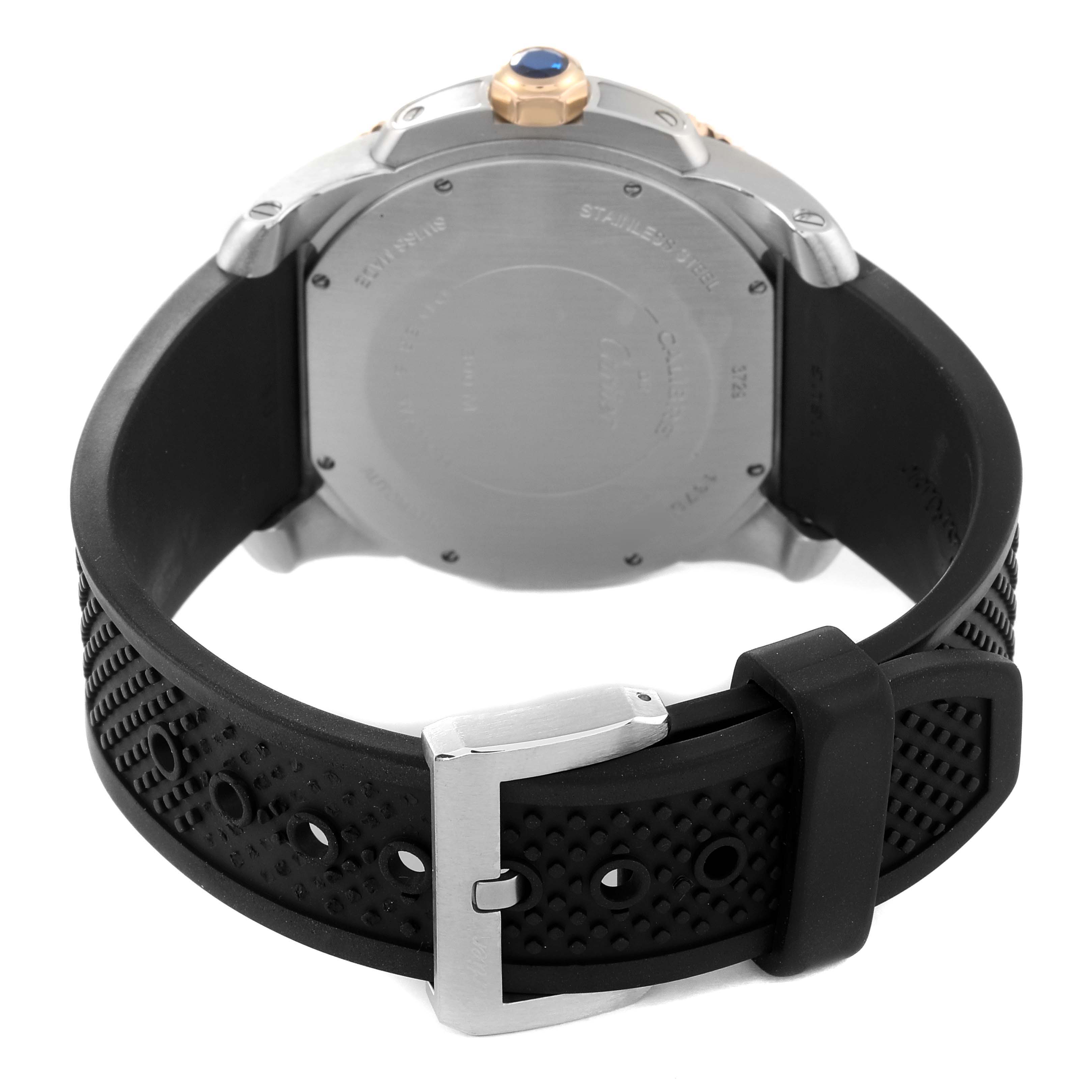 The image shows the back of a Calibre de Cartier watch by Cartier, including the back case and black rubber strap with buckle.