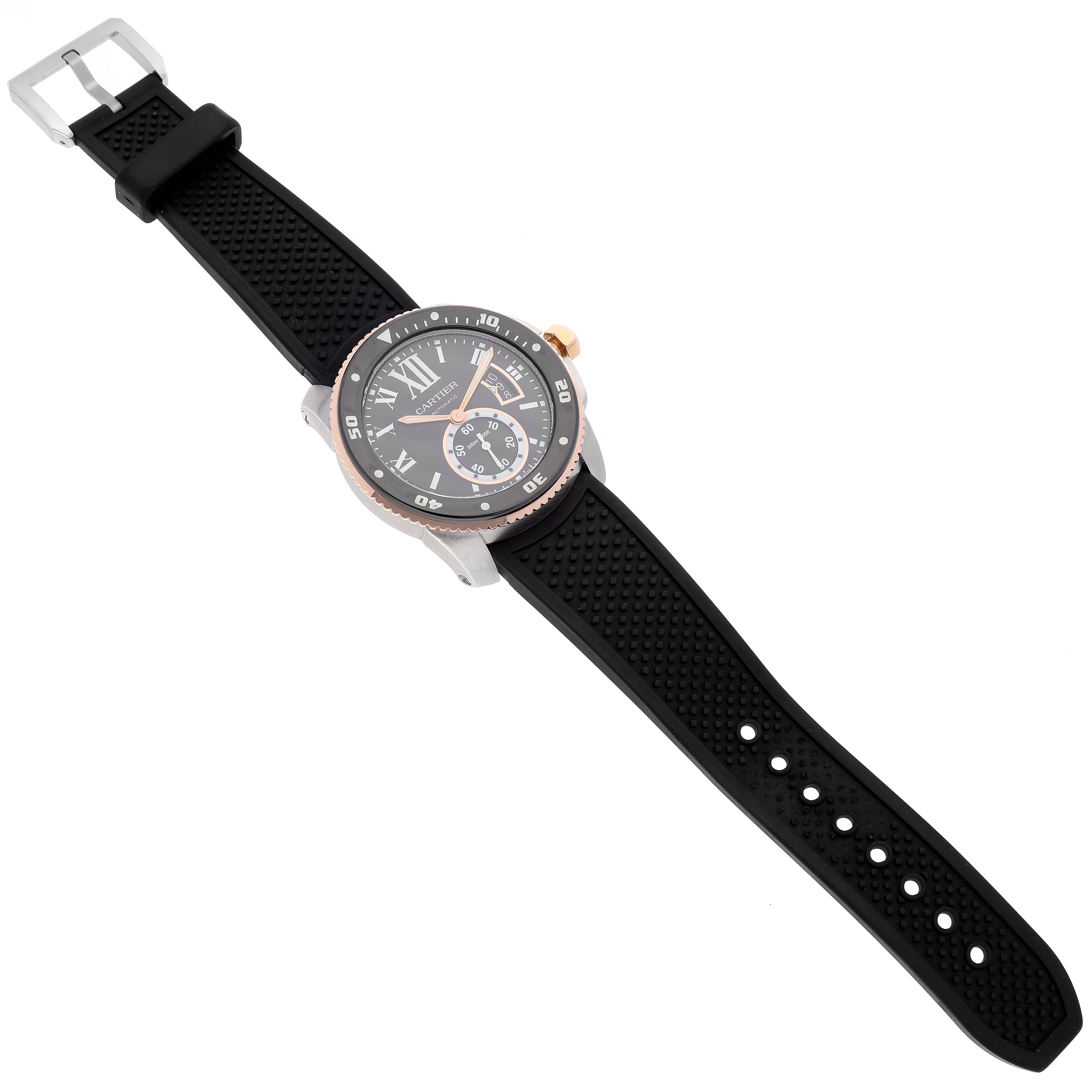 The image shows a top-down view of the Calibre de Cartier watch by Cartier, highlighting its black strap and bezel.