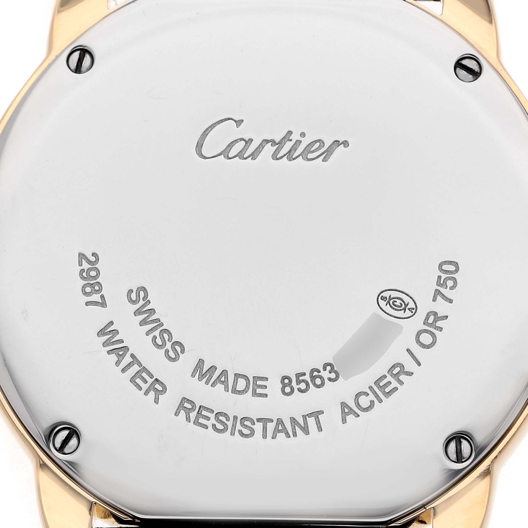 The image shows the back case of a Cartier Ronde W6700355 Women's Yellow Gold Silver Dial watch, featuring engraved details about its model and material.