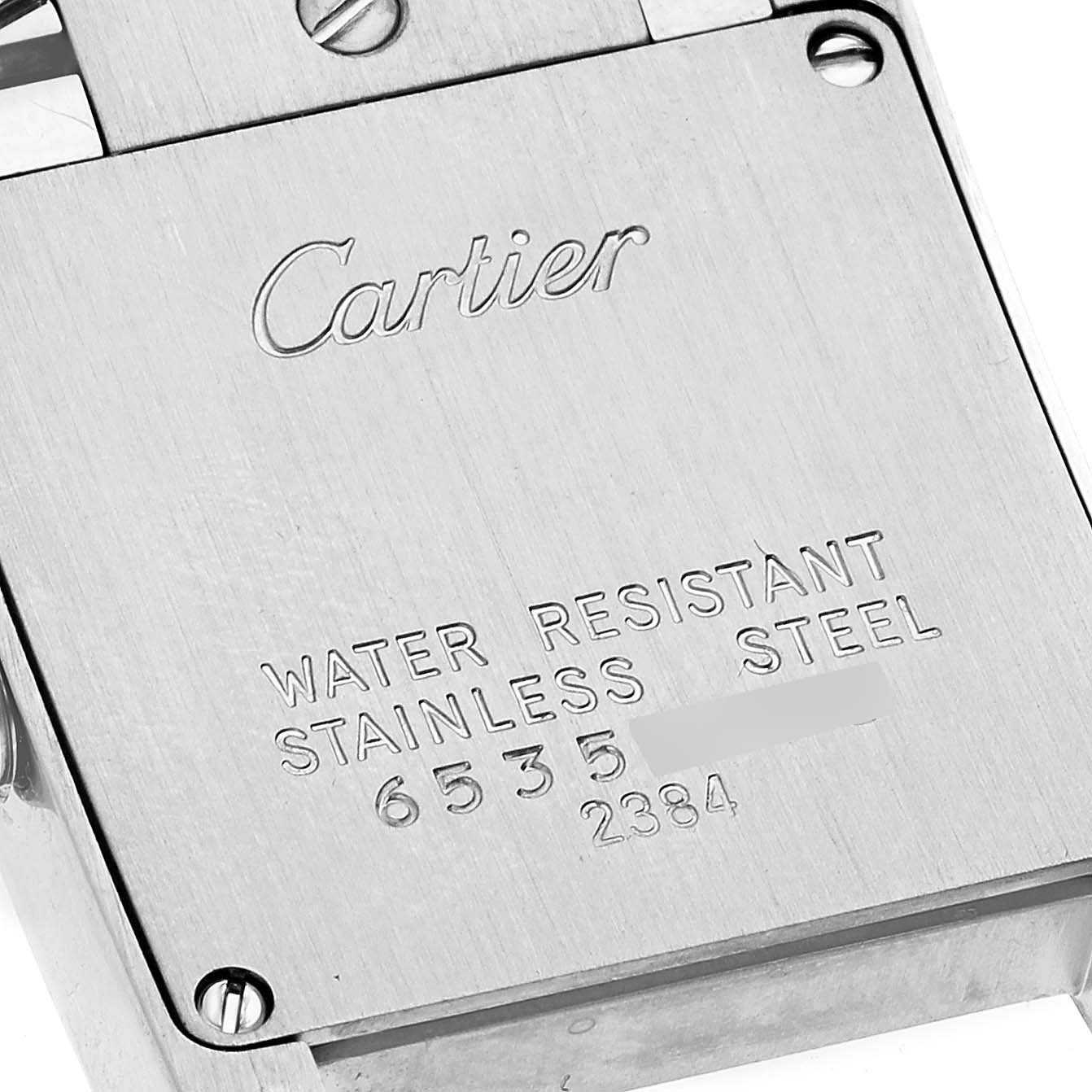 This image shows the back case of the Cartier Tank Francaise W51008Q3 Women
s Stainless Steel Silver Dial W51008Q3 Women
s Stainless Steel Silver Dial watch, highlighting its inscriptions and screws.