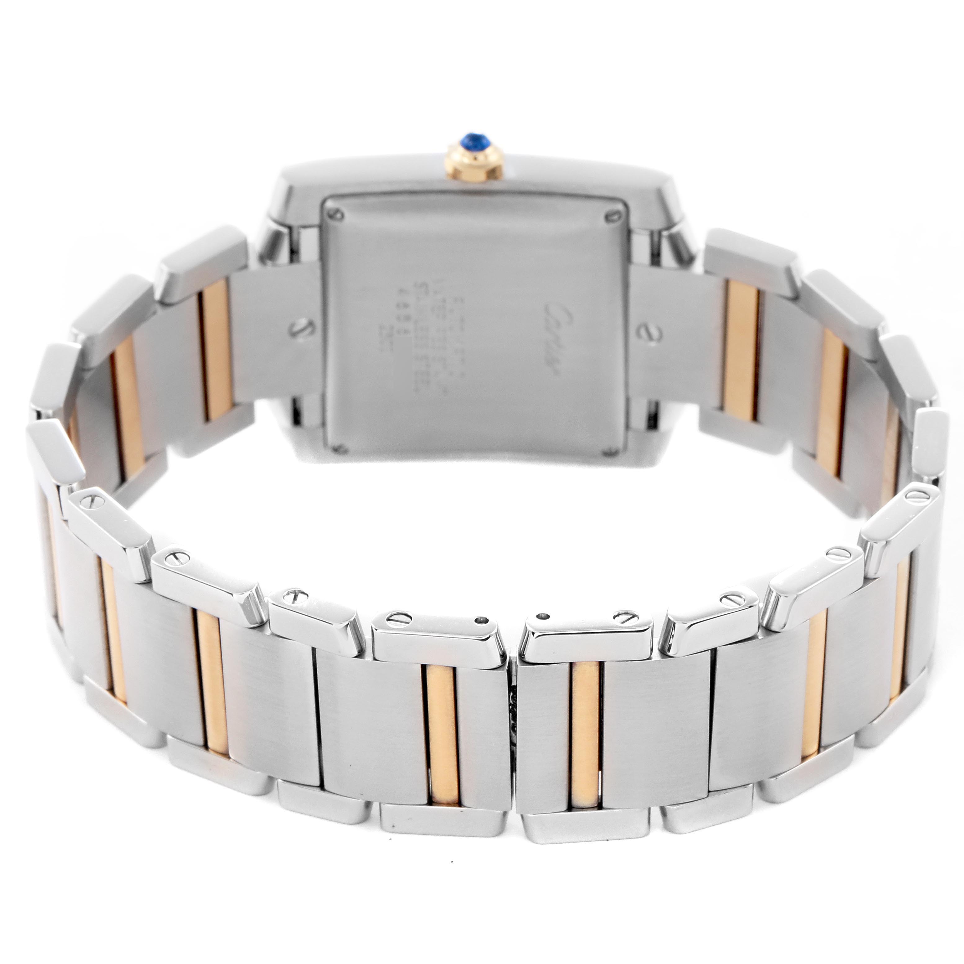 The image shows the back view of a Cartier Tank Française watch, highlighting the clasp and two-tone metal bracelet.