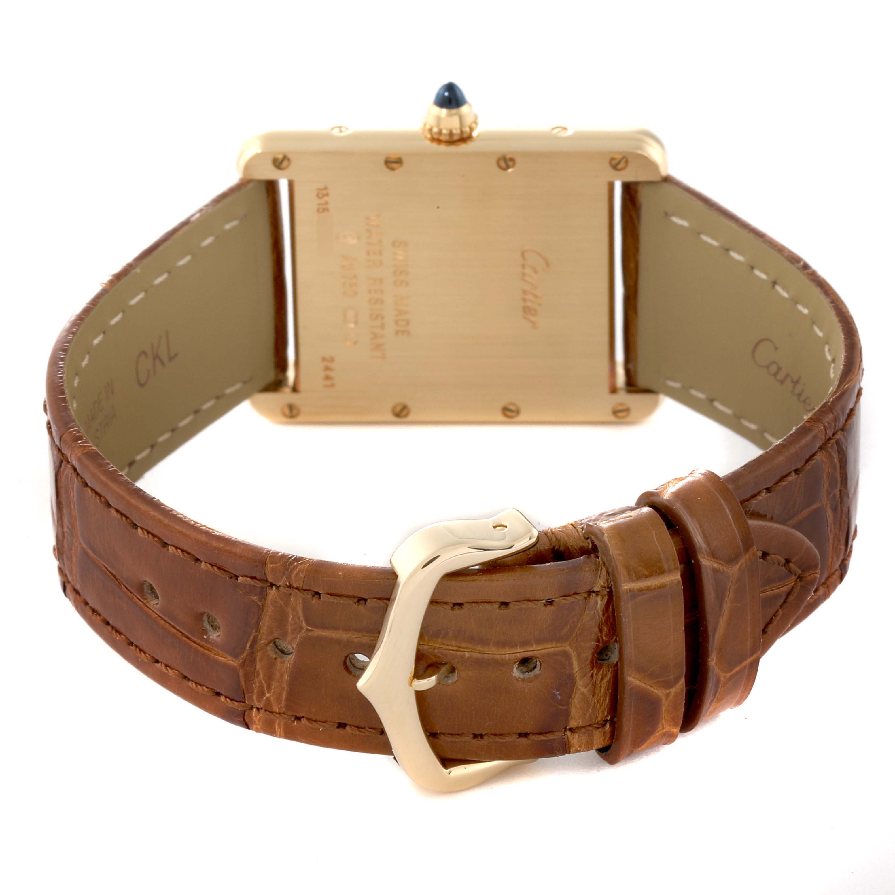 The image shows the back view of a Cartier Tank Louis W1529756 Men's Yellow Gold Silver Dial W1529756 Men's Yellow Gold Silver Dial watch, featuring its case back, crown, and leather strap with buckle.