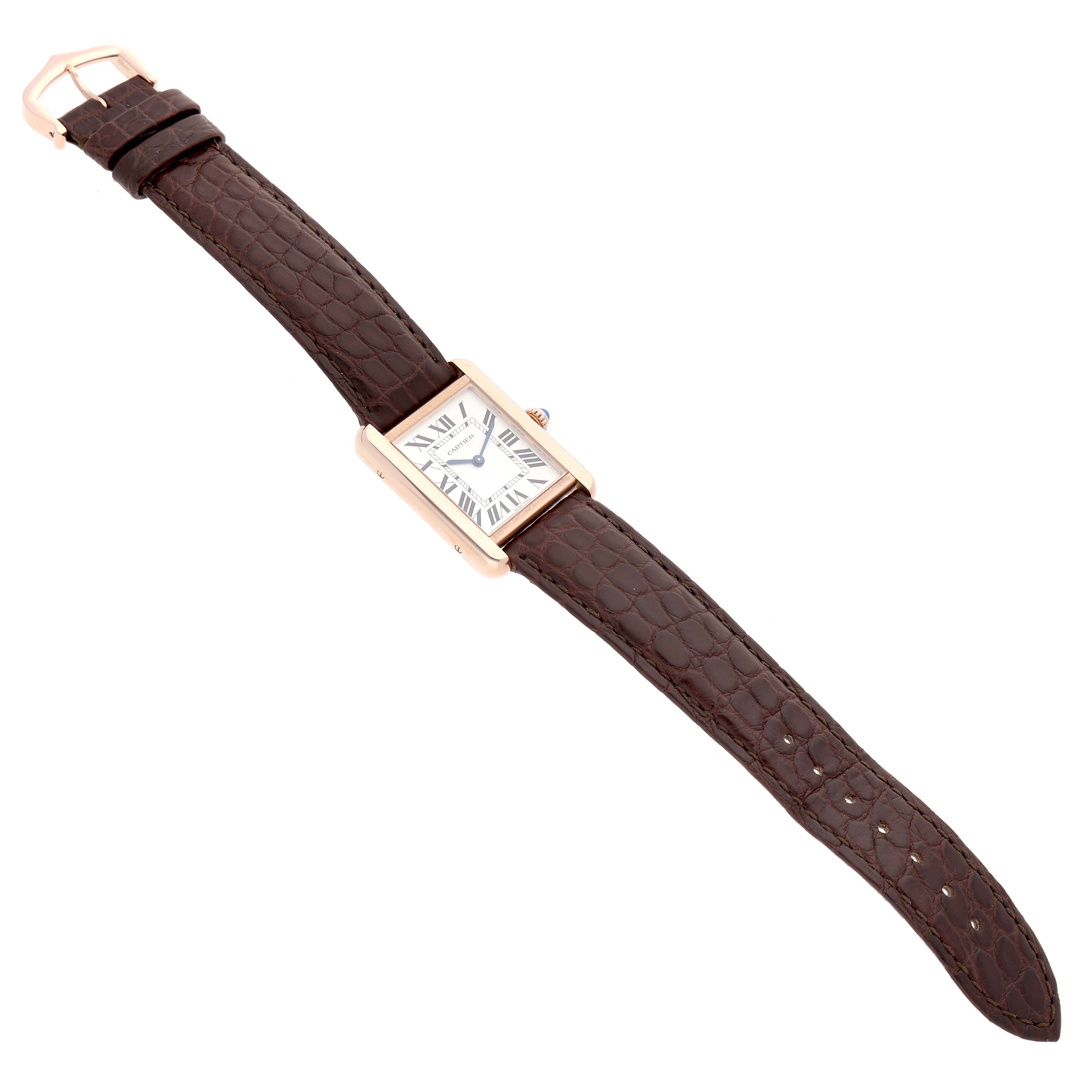 The Cartier Tank Solo W5200024 Women's Rose Gold Silver Dial watch is shown from a top angle, displaying its face, brown leather strap, and buckle.