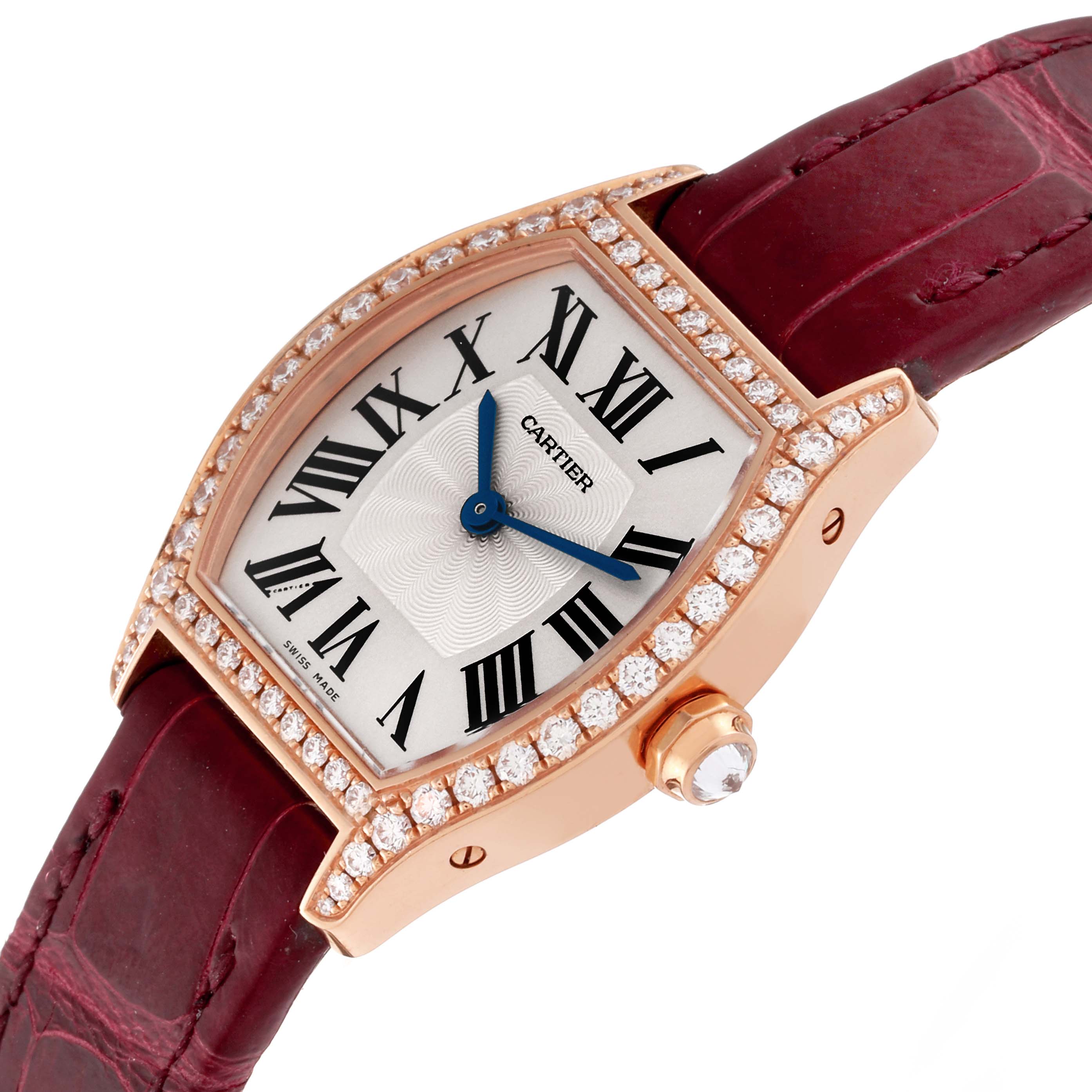 The Cartier Tortue WA501010 Women's Rose Gold Silver Dial WA501010 Women's Rose Gold Silver Dial watch is shown at an angle highlighting its diamond bezel, face with Roman numerals, and a red leather strap.
