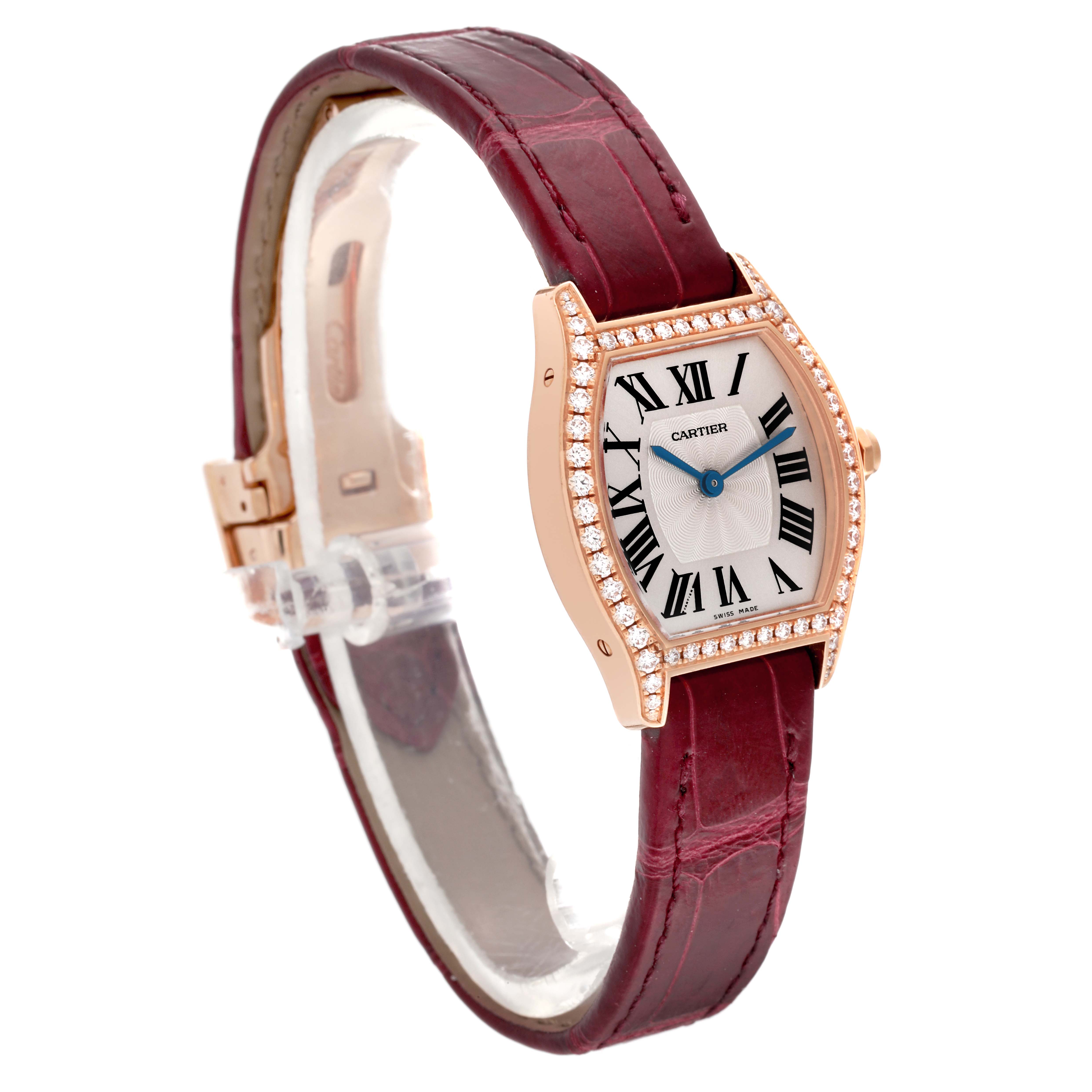 The Cartier Tortue WA501010 Women's Rose Gold Silver Dial WA501010 Women's Rose Gold Silver Dial watch is shown at a slight side angle, featuring a diamond-set bezel, Roman numeral dial, and a maroon leather strap.