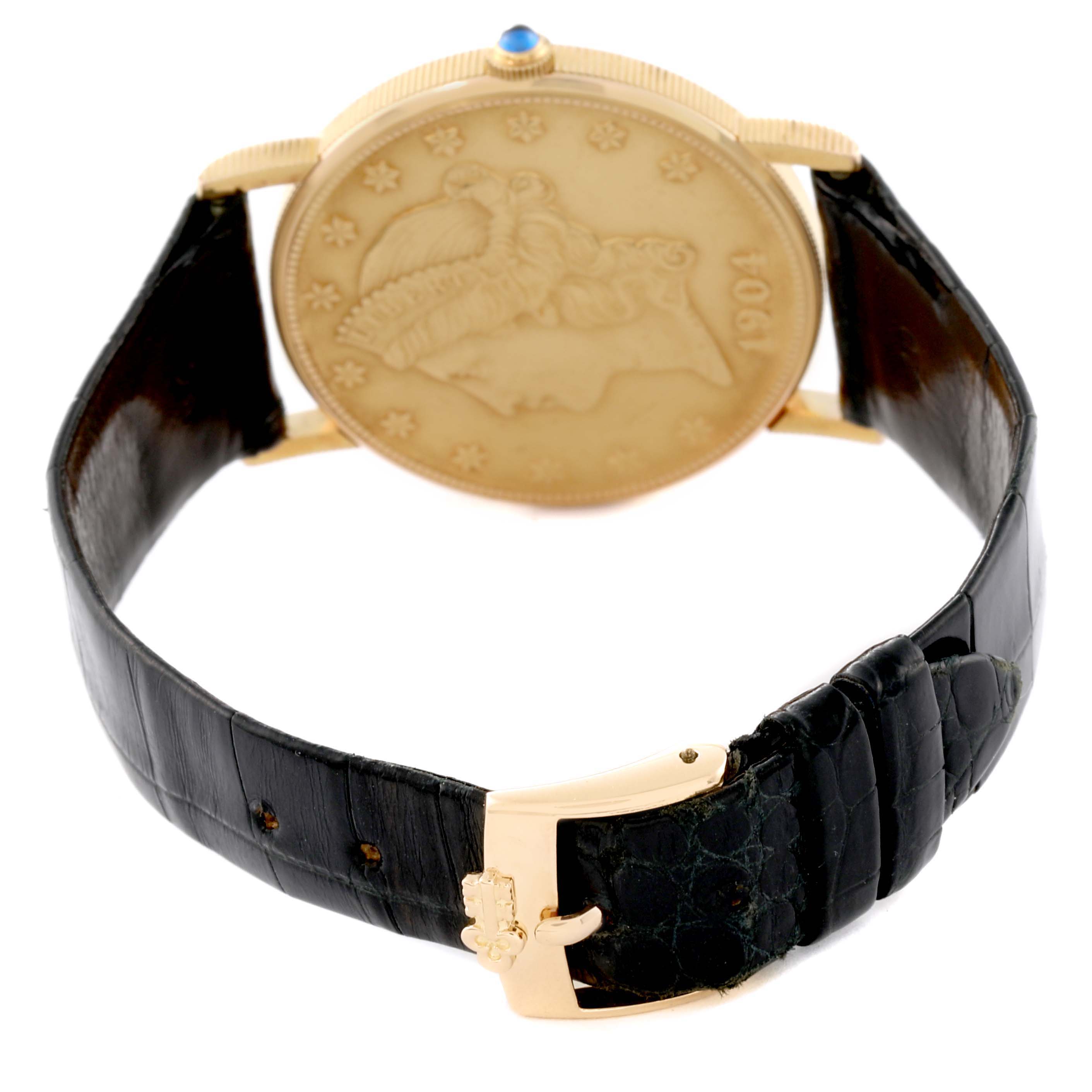 The image shows the back of a Corum Coin Watch Men's Yellow Gold Yellow Dial Men's Yellow Gold Yellow Dial model, highlighting its coin design and black leather strap with a gold buckle.