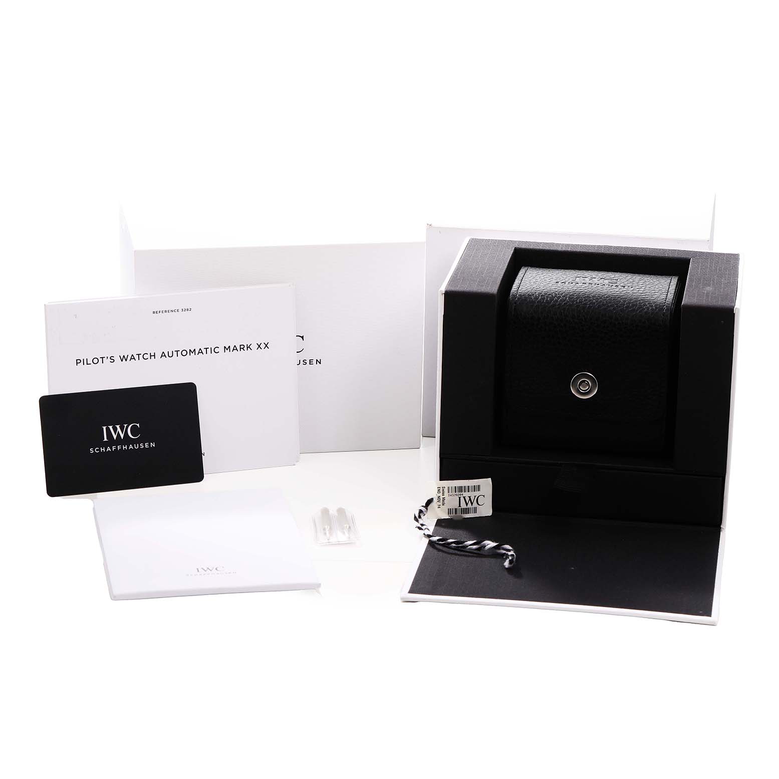 The image shows the packaging and accessories for an IWC Pilot IW328204 Men's Stainless Steel Blue Dial’s Watch Automatic Mark XX, including the box, manual, and tags.