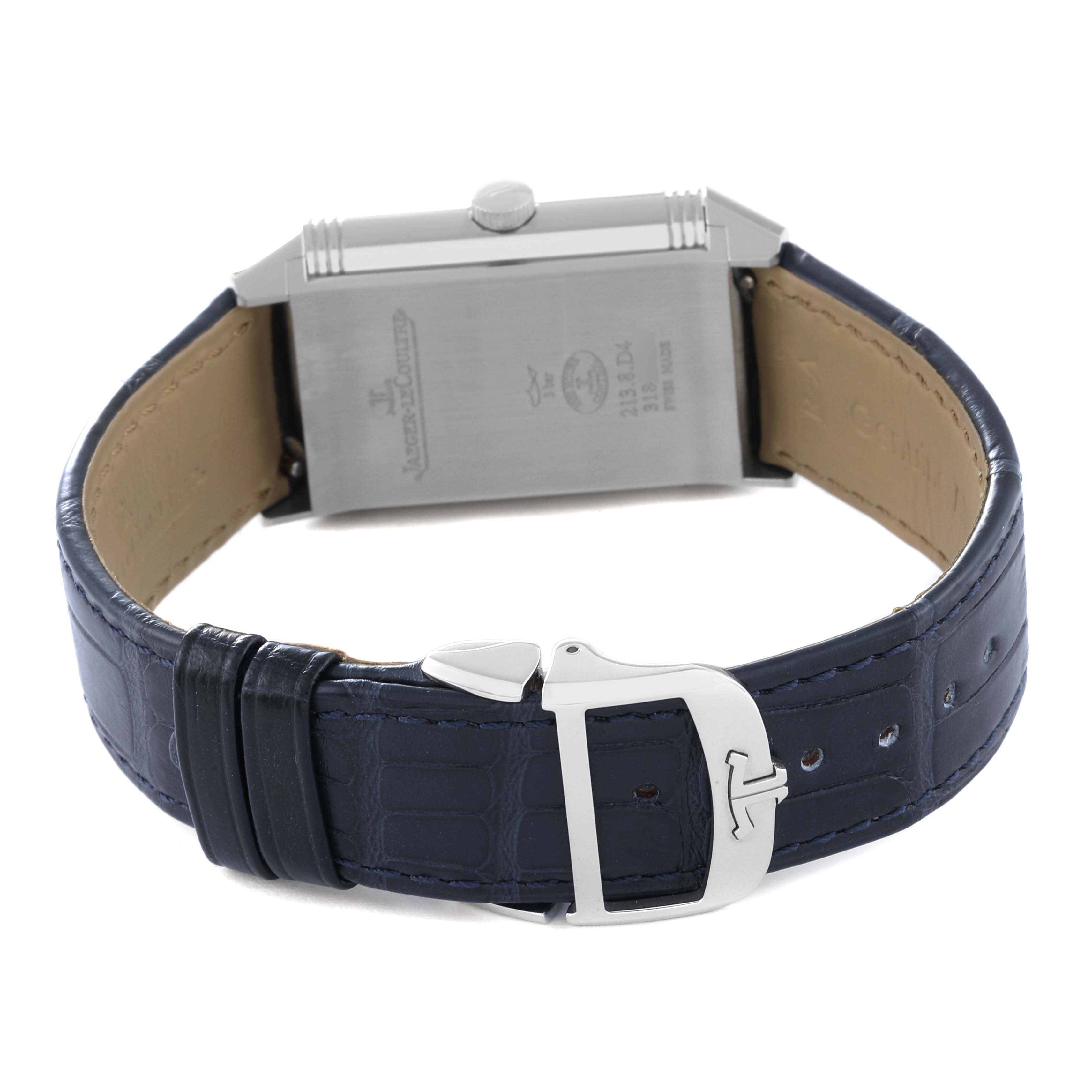 The image shows the Jaeger-LeCoultre Reverso watch from a rear-side angle, displaying the case back and leather strap with a buckle.