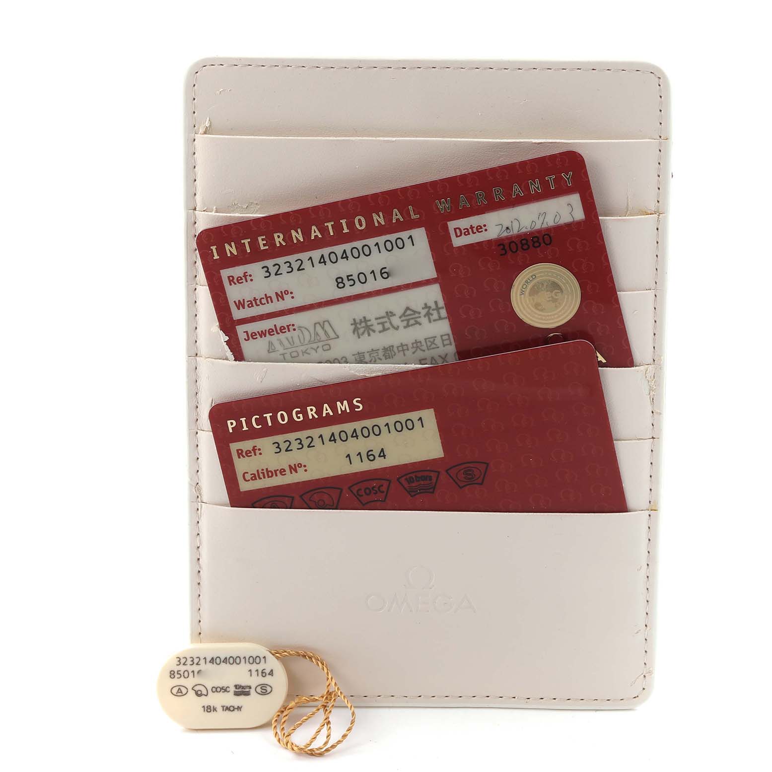 The image shows Omega Speedmaster 323.21.40.40.01.001 Men
s Steel and Gold (two tone) Black Dial 323.21.40.40.01.001 Men
s Steel and Gold (two tone) Black Dial watch cards and a tag stored in a white cardholder, viewed from a front angle.